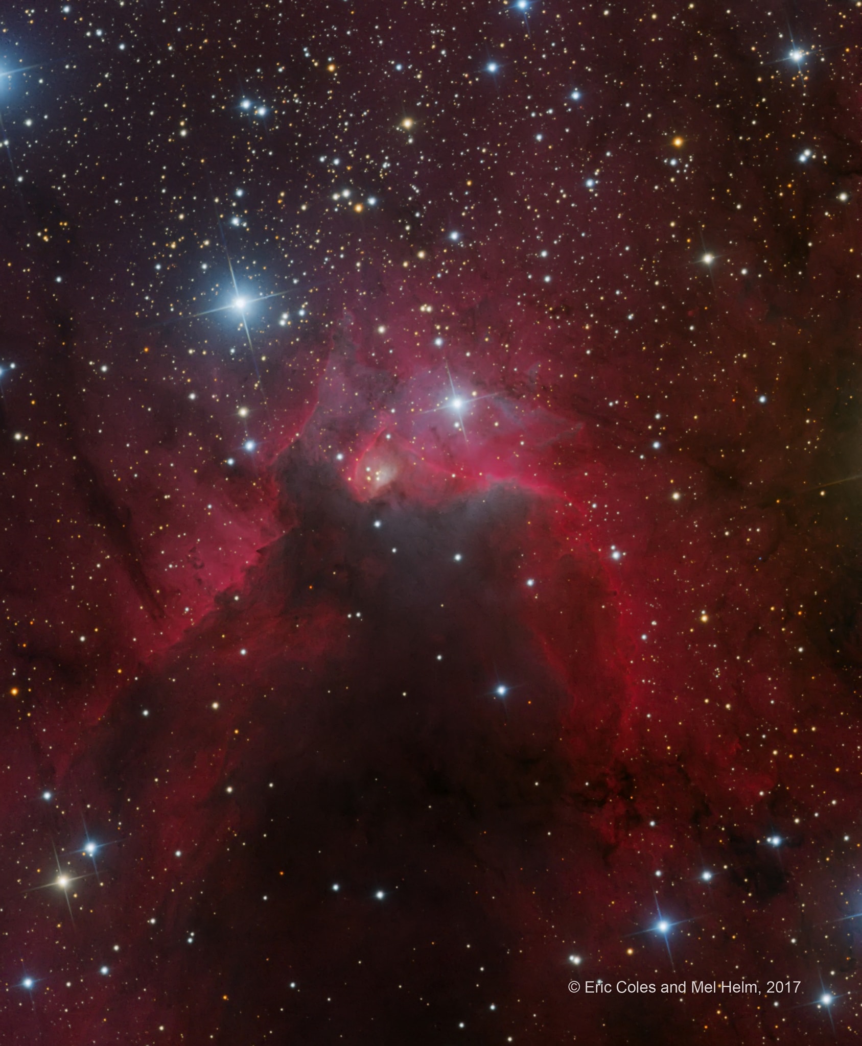 This skyscape features dusty Sharpless catalog emission region Sh2-155, the Cave Nebula. In the telescopic image, data taken through a narrowband filter tracks the reddish glow of ionized hydrogen atoms. About 2,400 light-years away, the scene lies along the plane of our Milky Way Galaxy toward the royal northern constellation of Cepheus. Astronomical explorations of the region reveal that it has formed at the boundary of the massive Cepheus B molecular cloud and the hot, young stars of the Cepheus OB 3 association. The bright rim of ionized hydrogen gas is energized by radiation from the hot stars, dominated by the brightest star above and left of picture center. Radiation driven ionization fronts are likely triggering collapsing cores and new star formation within. Appropriately sized for a stellar nursery, the cosmic cave is over 10 light-years across.