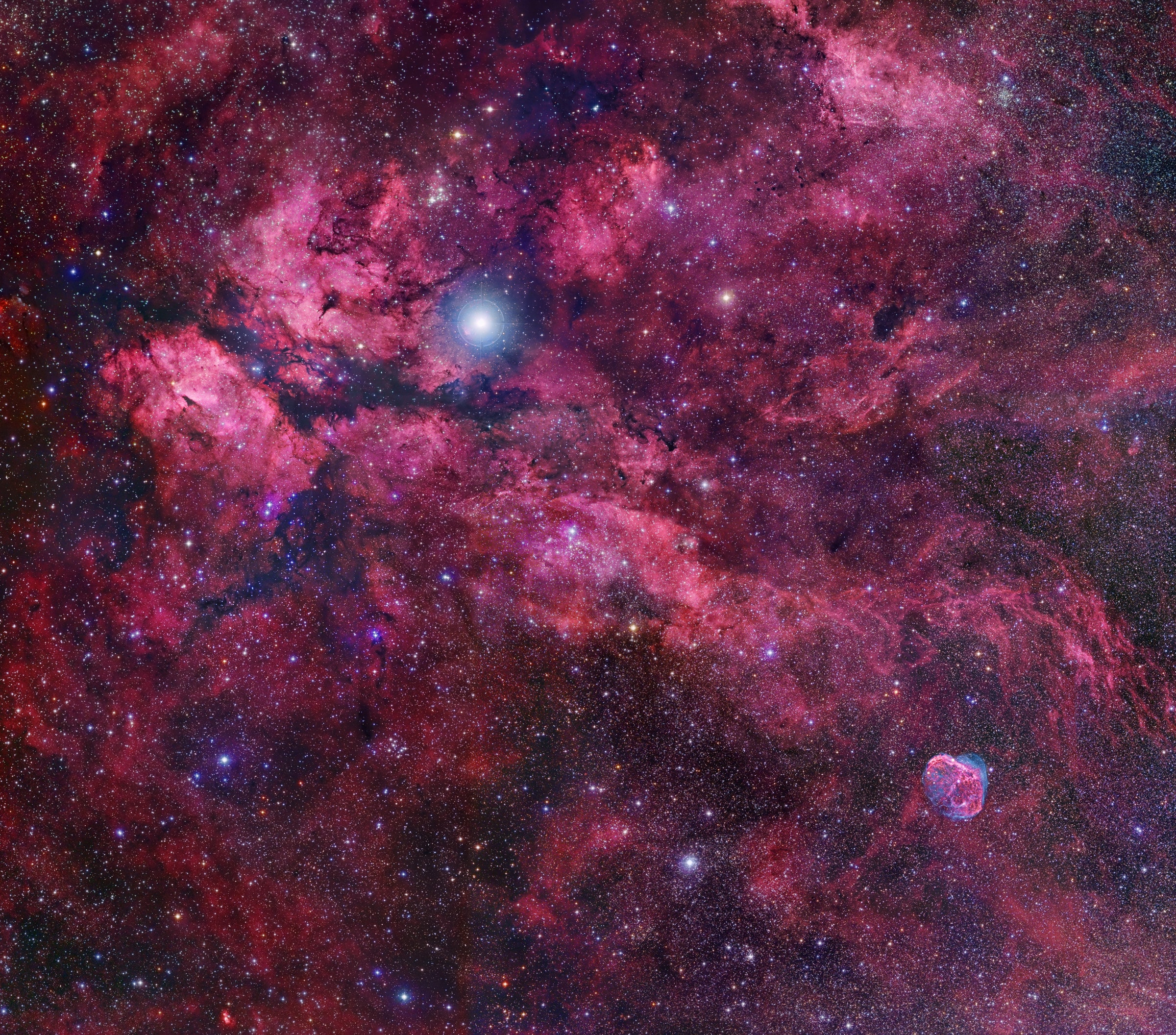 In cosmic brush strokes of glowing hydrogen gas, this beautiful skyscape unfolds across the plane of our Milky Way Galaxy near the northern end of the Great Rift and the center of the constellation Cygnus the Swan. A 36 panel mosaic of telescopic image data, the scene spans about six degrees. Bright supergiant star Gamma Cygni (Sadr) to the upper left of the image center lies in the foreground of the complex gas and dust clouds and crowded star fields. Left of Gamma Cygni, shaped like two luminous wings divided by a long dark dust lane is IC 1318 whose popular name is understandably the Butterfly Nebula. The more compact, bright nebula at the lower right is NGC 6888, the Crescent Nebula. Some distance estimates for Gamma Cygni place it at around 1,800 light-years while estimates for IC 1318 and NGC 6888 range from 2,000 to 5,000 light-years.