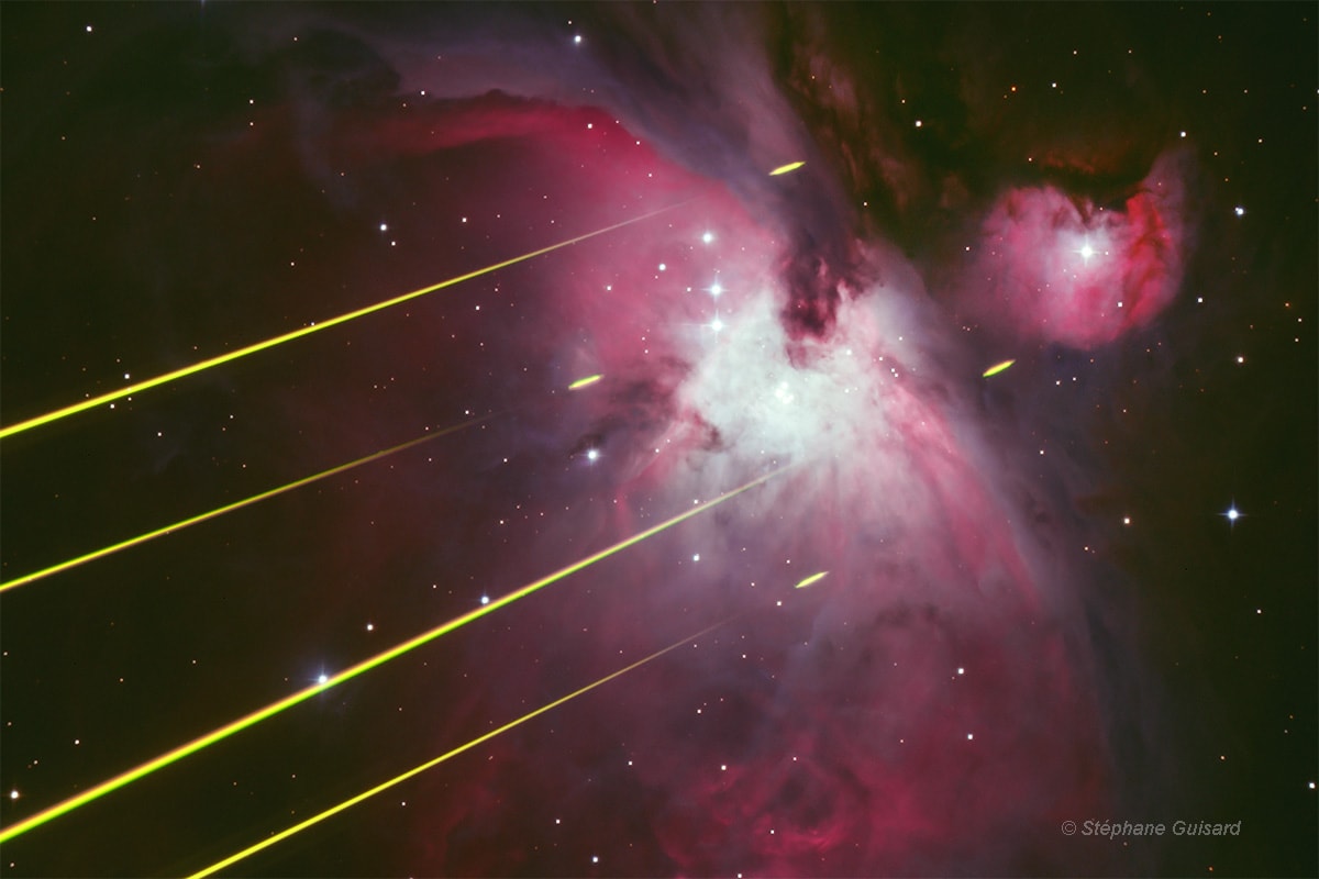 Four laser beams cut across this startling image of the Orion Nebula, as seen from ESO's Paranal Observatory in the Atacama desert on planet Earth. Not part of an interstellar conflict, the lasers are being used for an observation of Orion by UT4, one of the observatory's very large telescopes, in a technical test of an image-sharpening adaptive optics system. This view of the nebula with laser beams was captured by a small telescope from outside the UT4 enclosure. The beams are visible from that perspective because in the first few kilometers above the observatory the Earth's dense lower atmosphere scatters the laser light. The four small segments appearing beyond the beams are emission from an atmospheric layer of sodium atoms excited by the laser light at higher altitudes of 80-90 kilometers. Seen from the perspective of the UT4, those segments form bright spots or artificial guide stars. Their fluctuations are used in real-time to correct for atmospheric blurring along the line-of-sight by controlling a deformable mirror in the telescope's optical path.