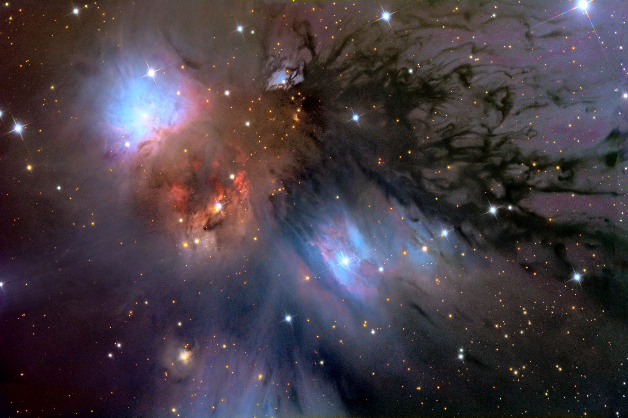In this beautiful celestial still life composed with a cosmic brush, dusty nebula NGC 2170 shines at the upper left. Reflecting the light of nearby hot stars, NGC 2170 is joined by other bluish reflection nebulae, a compact red emission region, and streamers of obscuring dust against a backdrop of stars. Like the common household items still life painters often choose for their subjects, the clouds of gas, dust, and hot stars pictured here are also commonly found in this setting - a massive, star-forming molecular cloud in the constellation of the Unicorn (Monoceros). The giant molecular cloud, Mon R2, is impressively close, estimated to be only 2,400 light-years or so away. At that distance, this canvas would be about 15 light-years across.