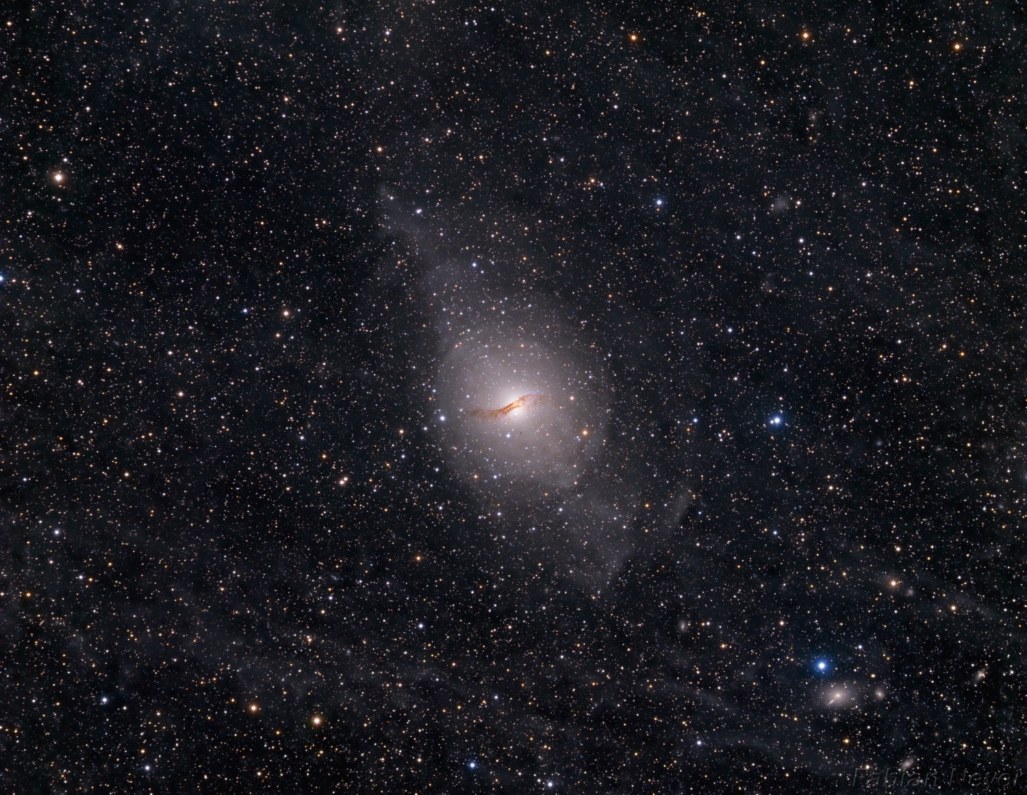 Only 11 million light-years away, Centaurus A is the closest active galaxy to planet Earth. Spanning over 60,000 light-years, the peculiar elliptical galaxy also known as NGC 5128, is featured in this sharp telescopic view. Centaurus A is apparently the result of a collision of two otherwise normal galaxies resulting in a fantastic jumble of star clusters and imposing dark dust lanes. Near the galaxy's center, left over cosmic debris is steadily being consumed by a central black hole with a billion times the mass of the Sun. As in other active galaxies, that process likely generates the radio, X-ray, and gamma-ray energy radiated by Centaurus A. The remarkably deep, visible light image offers further evidence of the ensuing cosmic violence in the faint shells and extended features surrounding the active galaxy.