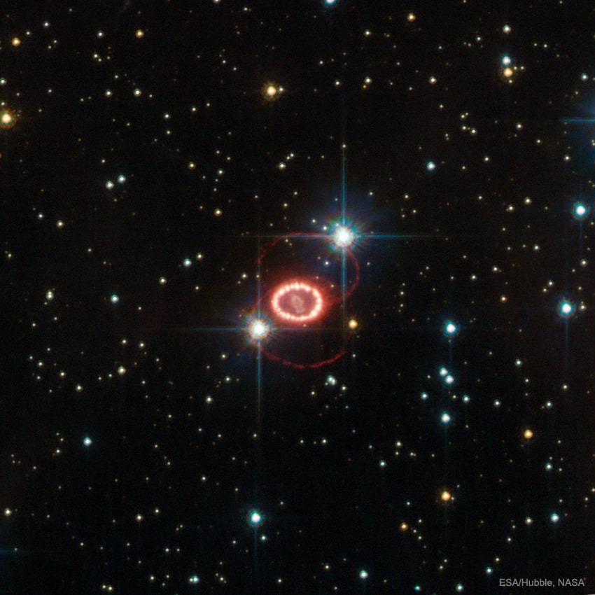 What's causing those odd rings in supernova 1987A?  Thirty years ago, in 1987, the brightest supernova in recent history was seen in the Large Magellanic Cloud. At the center of the featured picture is an object central to the remains of the violent stellar explosion. Surrounding the center are curious outer rings appearing as a flattened figure 8.  Although large telescopes including the Hubble Space Telescope monitor the curious rings every few years, their origin remains a mystery.  Pictured here is a Hubble image of the SN1987A remnant taken in 2011. Speculation into the cause of the rings includes beamed jets emanating from an otherwise hidden neutron star left over from the supernova, and the interaction of the wind from the progenitor star with gas released before the explosion.