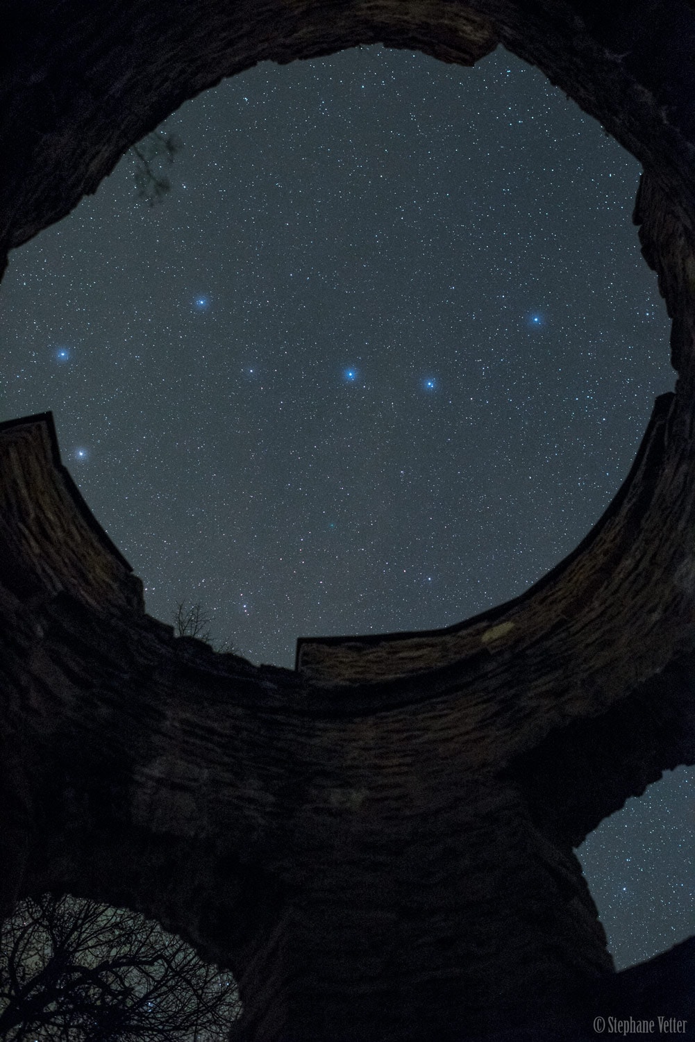 The best known asterism in northern skies, The Big Dipper is easy to recognize, even when viewed upside down, though some might see a plough or wagon. The star names and the familiar outlines appear framed in the ruined tower walls of the French Chateau du Morimont if you just slide your cursor over the image or follow this link. Dubhe, alpha star of the dipper's parent constellation Ursa Major is at the lower left. Together with beta star Merak the two form a line pointing the way to Polaris and the North Celestial Pole, hidden from view by the stones. Since the image was captured on March 30, you can follow a line from dipper stars Phecda and Megrez to spot the faint greenish glow of Comet 41P/Tuttle-Giacobini-Kresak below center, still within the castle eye view. The periodic comet made a remarkable close approach to planet Earth on April 1.