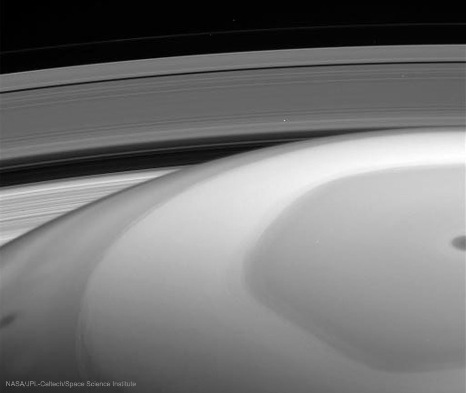 This is what Saturn looks like from inside the rings. Last week, for the first time, NASA directed the Cassini spacecraft to swoop between Saturn and its rings. During the dive, the robotic spacecraft took hundreds of images showing unprecedented detail for structures in Saturn's atmosphere. Looking back out, however, the spacecraft was also able to capture impressive vistas. In the featured image taken a few hours before closest approach, Saturn's unusual northern hexagon is seen surrounding the North Pole. Saturn's B ring is the closest visible, while the dark Cassini Division separates B from the outer A.  A close inspection will find the two small moons that shepherd the F-ring, the farthest ring discernable.  This image is raw and will be officially verified, calibrated and released at a later date.  Cassini remains on schedule to end its mission by plunging into Saturn's atmosphere on September 15.
