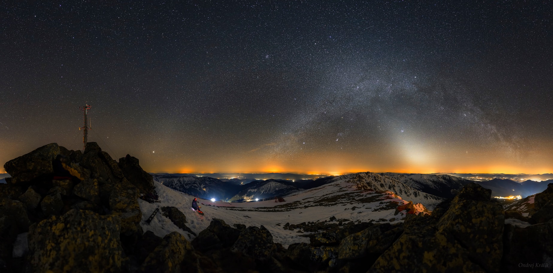 Two luminous arches stretched across the dome of the sky on this northern spring night. After sunset on March 29, the mountain view panorama was captured in 57 exposures from Chopok peak in central Slovakia at an altitude of about 2,000 meters. The arc of the northern Milky Way is visible toward the right, but only after it reaches above the terrestrial lights from the mountain top perspective. Though dusk has passed, a bright patch of celestial light still hovers near the horizon and fades into a second luminous arch of Zodiacal Light, crossing near the center of the Milky Way. Dust in the ecliptic plane reflects sunlight to create the Zodiacal glow, typically prominent after sunset in clear, dark, skies of the northern spring. Almost opposite the Sun, Jupiter shines brightly near the horizon toward the left. Since Jupiter lies near the ecliptic, it appears within the slight brightening of the Zodiacal band also opposite the Sun called the Gegenschein.