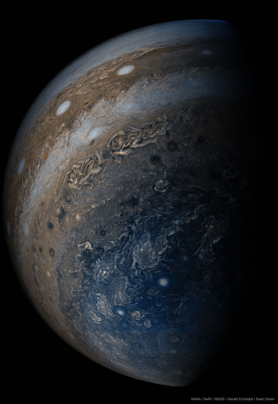 Jupiter is stranger than we knew. NASA's Juno spacecraft has now completed its sixth swoop past Jupiter as it moves around its highly elliptical orbit. Pictured, Jupiter is seen from below where, surprisingly, the horizontal bands that cover most of the planet disappear into swirls and complex patterns.  A line of white oval clouds is visible nearer to the equator.  Recent results from Juno show that Jupiter's weather phenomena can extend deep below its cloud tops, and that Jupiter's magnetic field varies greatly with location.  Juno is scheduled to orbit Jupiter 37 times with each orbit taking about six weeks.