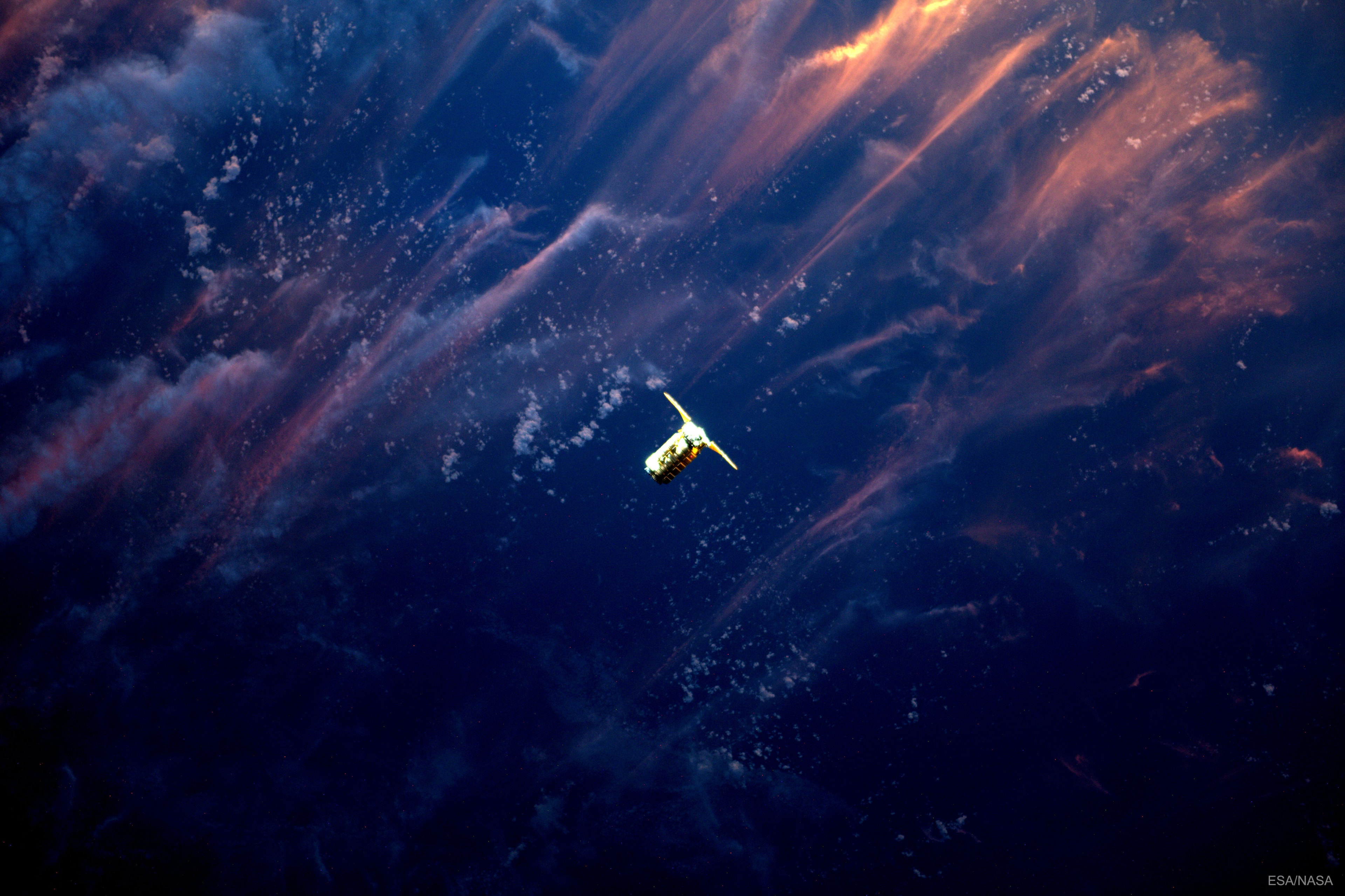 There it is!  The Cygnus supply ship was a welcome sight to the astronauts on the International Space Station just over a week ago. Launched three days before on a United Launch Alliance Atlas V from Cape Canaveral, Florida, the Orbital ATK's Cygnus spacecraft approached the International Space Station above the backdrop of a picturesque planet Earth.  The Sun was setting off the image to the upper left, illuminating clouds well below the approaching vehicle. The robotic Cygnus spacecraft was captured first on camera and later with the space station's Canadarm2 by ESA's Flight Engineer Thomas Pesquet and NASA's Expedition-51 Commander Peggy Whitson. Commander Whitson, a biochemist, has now set a new American record for the most total days in space.  Besides essentials, the Cygnus carried equipment to bolster over 200 science experiments being conducted on the football-field sized Earth-orbiting outpost.