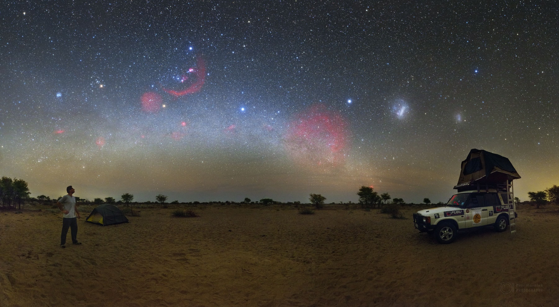 You wake up in the Kalahari Desert in Botswana, Africa.  You go outside your tent, set up your camera, and take long exposures of the land and sky.  What might you see? Besides a lot of blowing dust and the occasional acacia tree, you might catch many sky wonders. Pictured in 2015 September, sky highlights include the central band of our Milky Way Galaxy, the Pleiades Star Cluster, Barnard's Loop, and both the Large and Small Magellanic Clouds, to name just a few.  Although most of these faded in the morning light, they were quickly replaced by a partial eclipse of the Sun.    Free Presentation: APOD Editor to speak in Prague on June 30