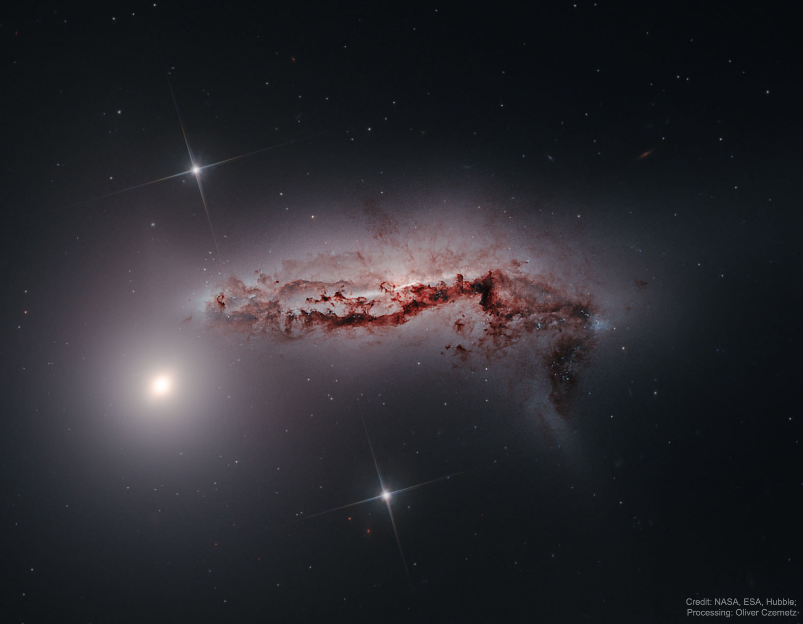 Scanning the skies for galaxies, Canadian astronomer Paul Hickson and colleagues identified some 100 compact groups of galaxies, now appropriately called Hickson Compact Groups (HCGs). This sharp Hubble image shows one such galaxy group, HCG 90, in startling detail. Three galaxies -- two visible here -- are revealed to be strongly interacting: a dusty spiral galaxy stretched and distorted in the image center, and two large elliptical galaxies. The close encounter will trigger furious star formation. On a cosmic timescale, the gravitational tug of war will eventually result in the merger of the trio into a large single galaxy. The merger process is now understood to be a normal part of the evolution of galaxies, including our own Milky Way. HCG 90 lies about 100 million light-years away toward the constellation of the Southern Fish (Piscis Austrinus). This Hubble view spans about 40,000 light-years at that estimated distance. Of course, Hickson Compact Groups also make for rewarding viewing for Earth-bound astronomers with more modest sized telescopes.