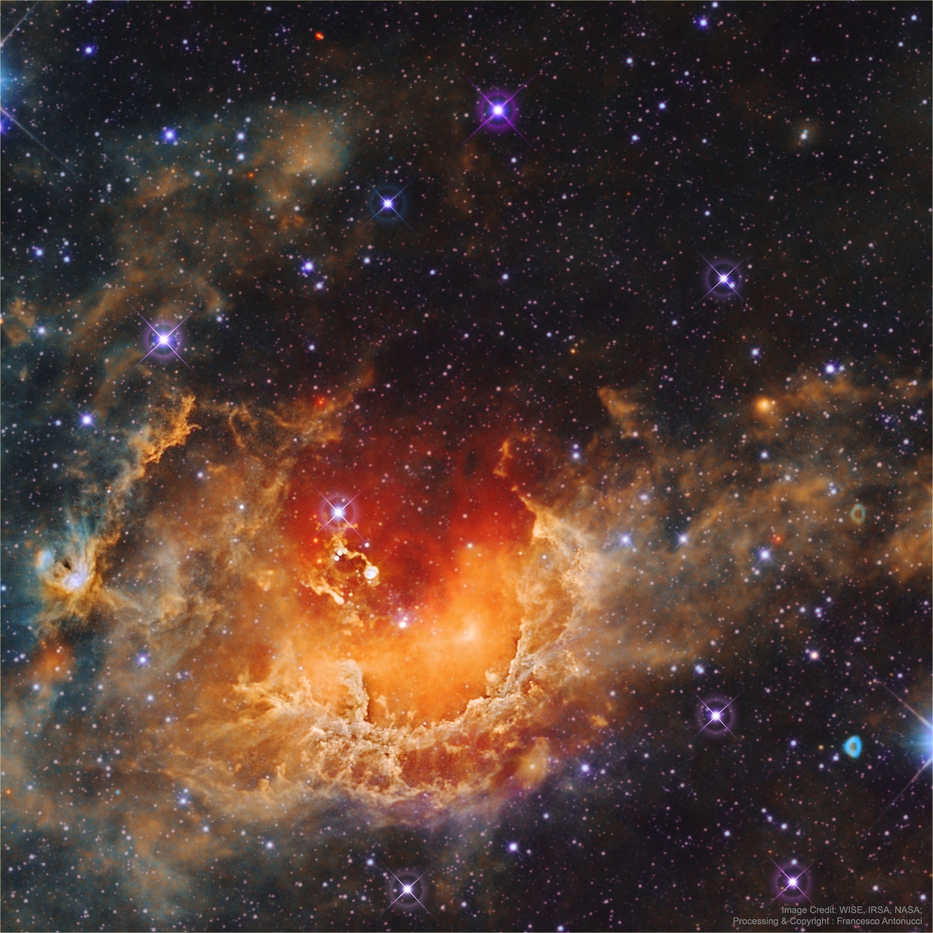 What's all of the commotion in the Tadpole nebula? Star formation.  Dusty emission in the Tadpole nebula, IC 410, lies about 12,000 light-years away in the northern constellation of the Charioteer (Auriga). The cloud of glowing gas is over 100 light-years across, sculpted by stellar winds and radiation from embedded open star cluster NGC 1893. Formed in the interstellar cloud a mere 4 million years ago, bright newly formed cluster stars are seen all around the star-forming nebula.  Notable near the image center are two relatively dense streamers of material trailing away from the nebula's central regions. Potentially sites of ongoing star formation in IC 410, these cosmic tadpole shapes are about 10 light-years long. The featured image was taken in infrared light by NASA's Wide Field Infrared Survey Explorer (WISE) satellite.   Open Science: Browse 1,400+ codes in the Astrophysics Source Code Library