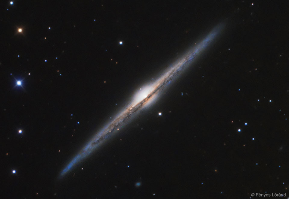 Is our Galaxy this thin?  We believe so. Magnificent spiral galaxy NGC 4565 is viewed edge-on from planet Earth. Also known as the Needle Galaxy for its narrow profile, bright NGC 4565 is a stop on many telescopic tours of the northern sky, in the faint but well-groomed constellation Coma Berenices. This sharp, colorful image reveals the galaxy's bulging central core cut by obscuring dust lanes that lace NGC 4565's thin galactic plane. An assortment of other background galaxies is included in the pretty field of view, with neighboring galaxy NGC 4562 at the upper left. NGC 4565 itself lies about 40 million light-years distant and spans some 100,000 light-years.  Easily spotted with small telescopes, sky enthusiasts consider NGC 4565 to be a prominent celestial masterpiece Messier missed.   Free Presentation: APOD Editor to speak in Prague on June 30