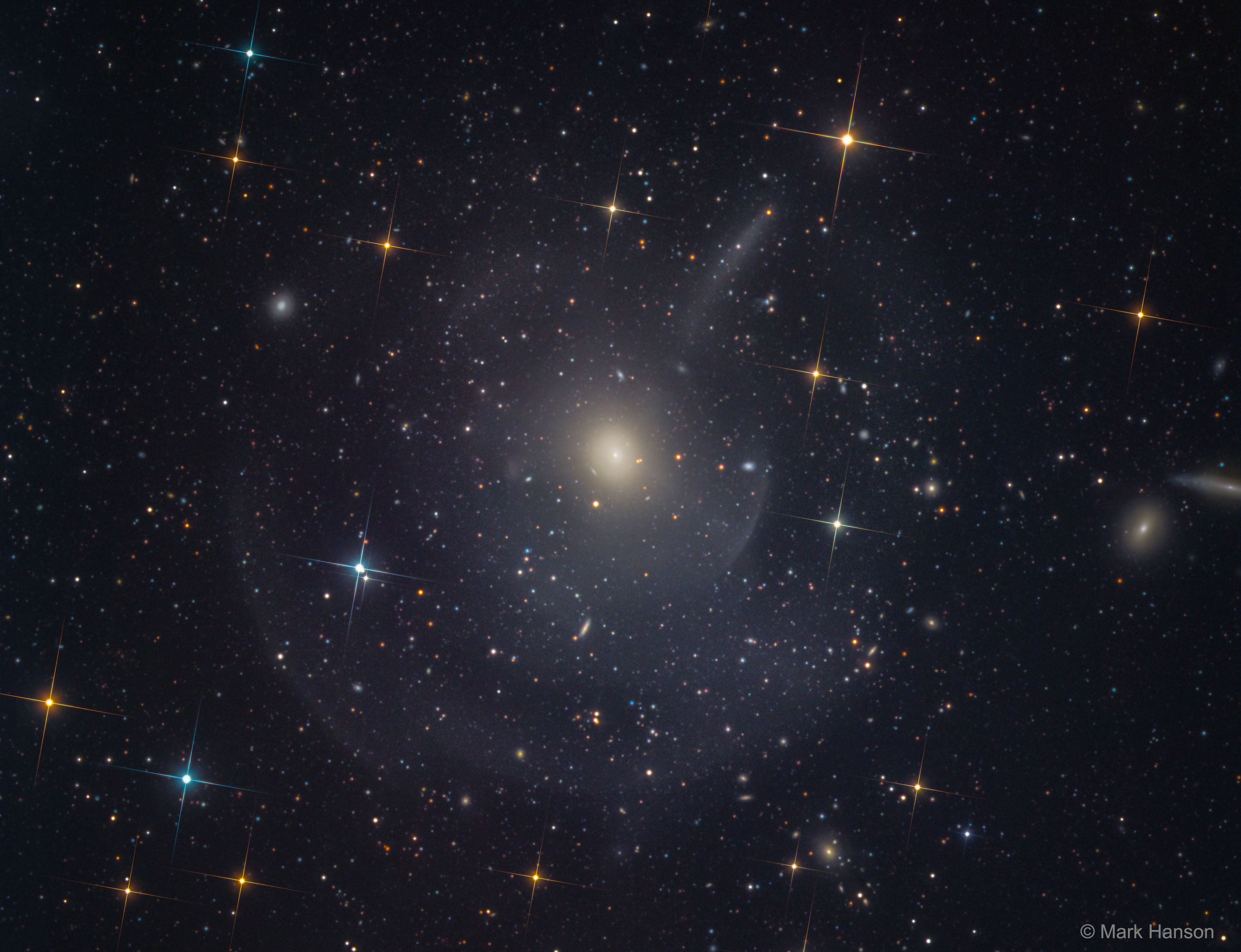 Can you see them? This famous Messier object M89, a seemingly simple elliptical galaxy, is surrounded by faint shells and plumes. The cause of the shells is currently unknown, but possibly tidal tails related to debris left over from absorbing numerous small galaxies in the past billion years. Alternatively the shells may be like ripples in a pond, where a recent collision with another large galaxy created  density waves that ripple through this galactic giant. Regardless of the actual cause, the featured image highlights the increasing consensus that at least some elliptical galaxies have formed in the recent past, and that the outer halos of most large galaxies are not really smooth but have complexities induced by frequent interactions with -- and accretions of -- smaller nearby galaxies. The halo of our own Milky Way Galaxy is one example of such unexpected complexity. M89 is a member of the nearby Virgo cluster of galaxies which lies about 50 million light years distant.   Follow APOD on: Facebook,  Google Plus,  Instagram, or Twitter
