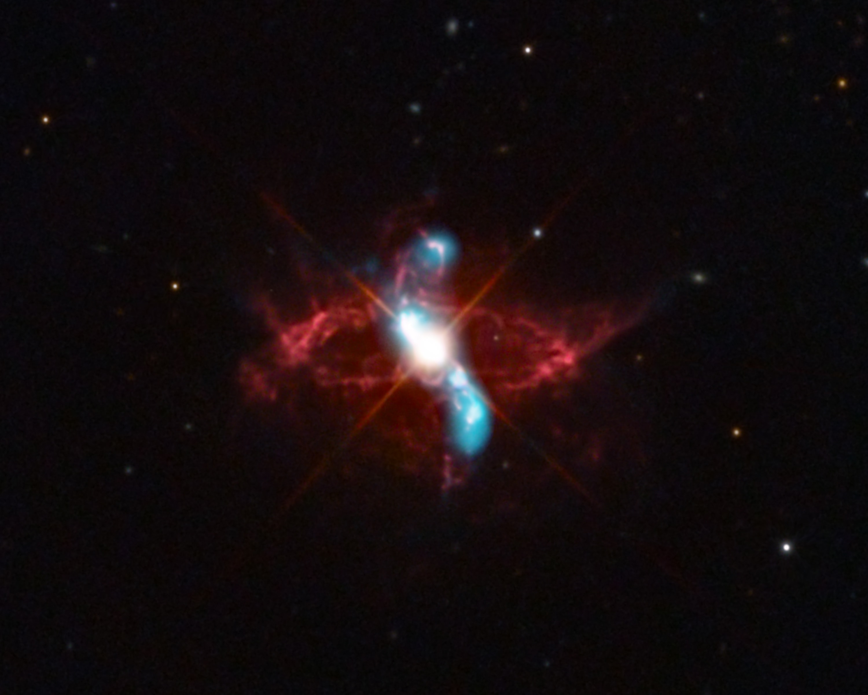 A long recognized naked-eye variable star, R Aquarii is actually an interacting binary star system, two stars that seem to have a close, symbiotic relationship. About 710 light years away, it consists of a cool red giant star and hot, dense white dwarf star in mutual orbit around their common center of mass. The binary system's visible light is dominated by the red giant, itself a Mira-type long period variable star. But material in the cool giant star's extended envelope is pulled by gravity onto the surface of the smaller, denser white dwarf, eventually triggering a thermonuclear explosion and blasting material into space. Optical image data (red) shows the still expanding ring of debris originating from a blast that would have been seen in the early 1770s. The evolution of less understood energetic events producing high energy emission in the R Aquarii system has been monitored since 2000 using Chandra X-ray Observatory data (blue). The composite field of view is less that a light-year across at the estimated distance of R Aquarii.