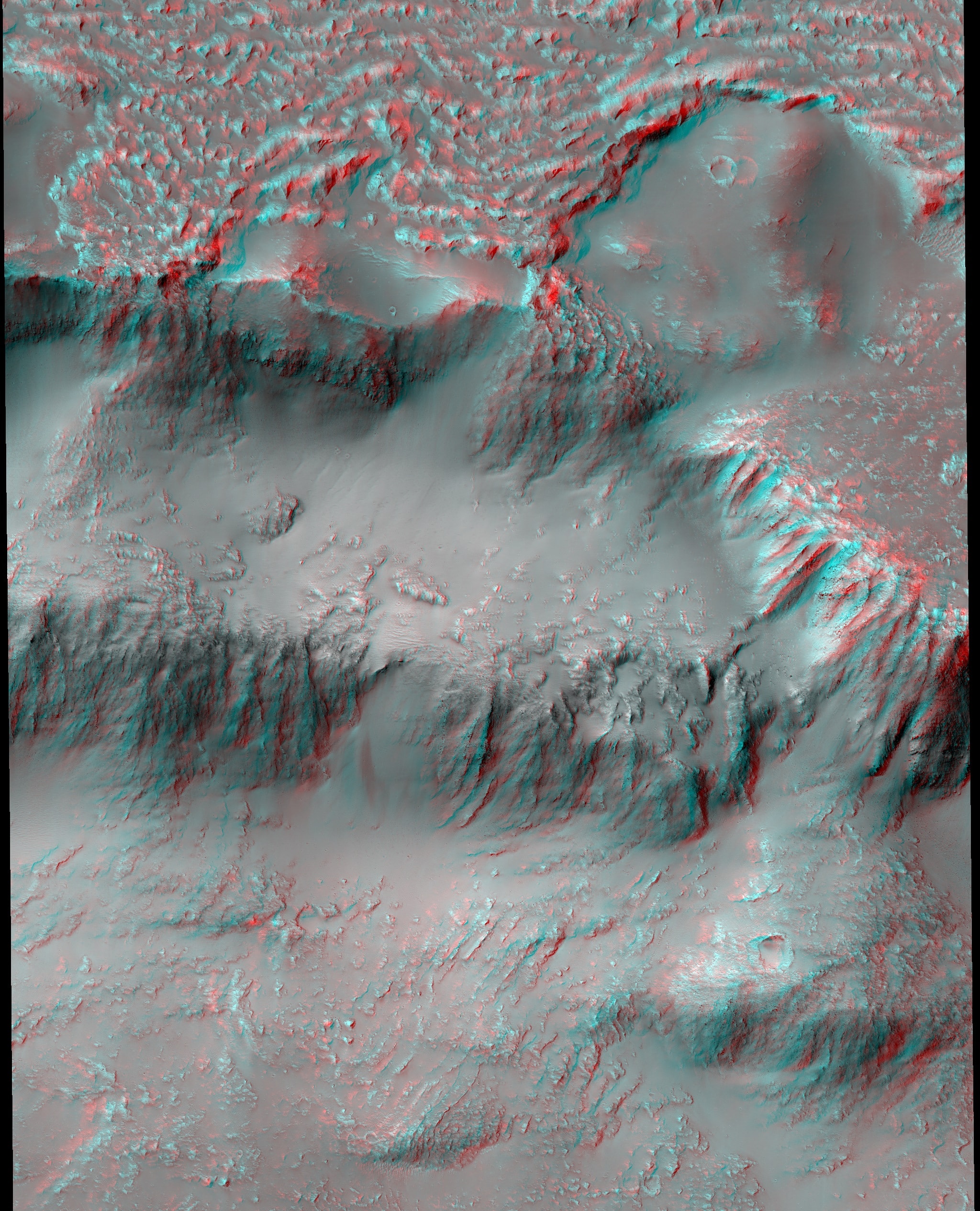 Get out your red/cyan glasses and gaze across lava falls of Mars. The stereo anaglyph was created by combining two images recorded by the HiRISE camera onboard Mars Reconnaissance Orbiter. The multi-level falls were created as flowing lava breached sections of the northern rim of a 30-kilometer diameter martian crater, located in the western part of the Red Planet's volcanic Tharsis region. As the molten lava cascaded down the crater wall and terraces to reach the crater floor it left the distinctly rough, fan-shaped flows on the steeper slopes. North is up and the breathtaking 3D view is 5 kilometers wide.