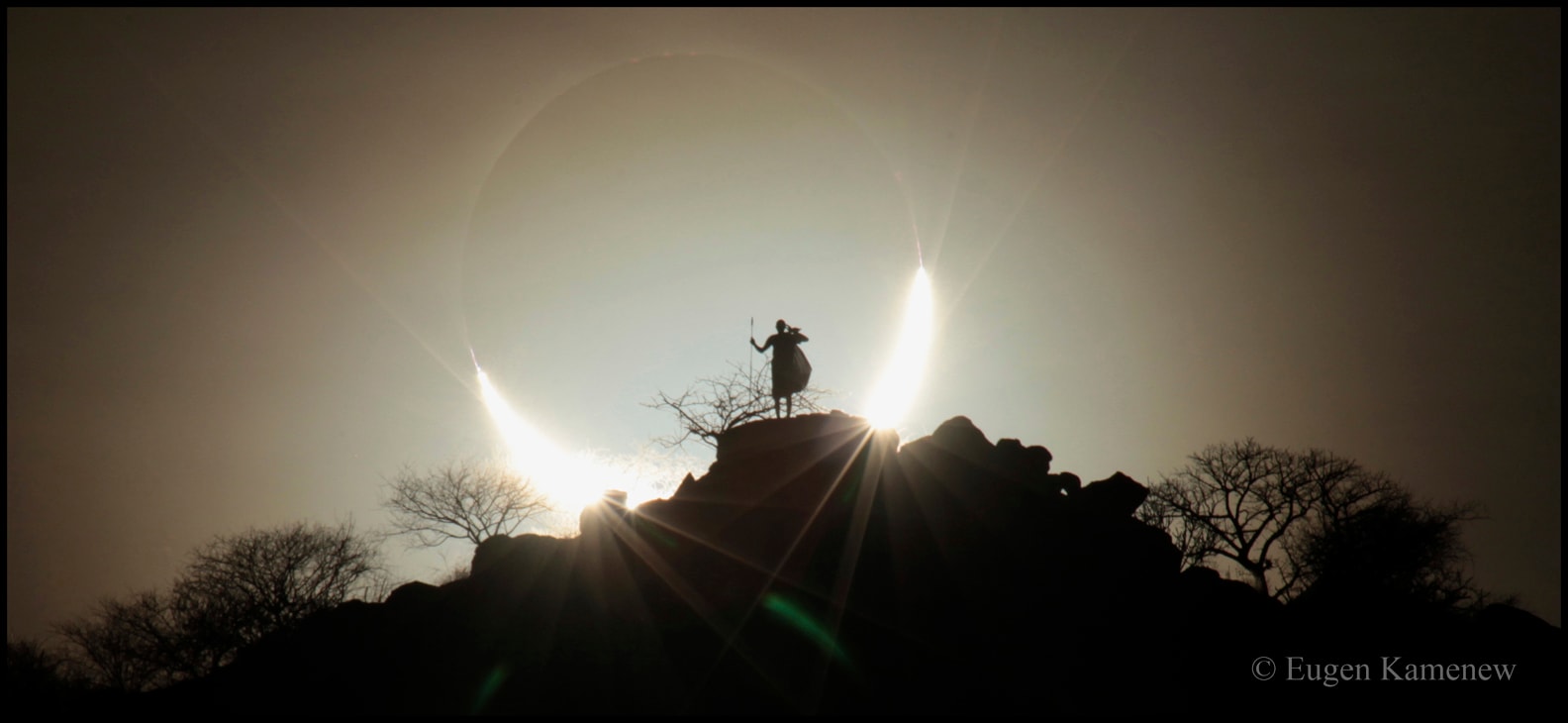 Chasing solar eclipses can cause you to go to the most interesting places and meet the most interesting people.  Almost.  For example, chasing this eclipse brought this astrophotographer to Kenya in 2013. His contact, a member of the Maasai people, was to pick him up at the airport, show him part of southern Kenya, and even agreed to pose in traditional warrior garb on a hill as the hopefully spectacular eclipse set far in background.  Unfortunately, this contact person died unexpectedly a week before the astrophotographer's arrival, and so he never got to participate in the shoot, nor know that the resulting image went on to win an international award for astrophotography.  Pictured in 2013 from Kenya, the Moon covers much of the Sun during a hybrid eclipse, a rare type of solar eclipse that appears as total from some Earth locations, but annular in others. During the annular part of the eclipse, the Moon was too far from the Earth to block the entire Sun.  Next month a total solar eclipse will cross the USA.   Share the Sky: NASA creates new Open API for APOD