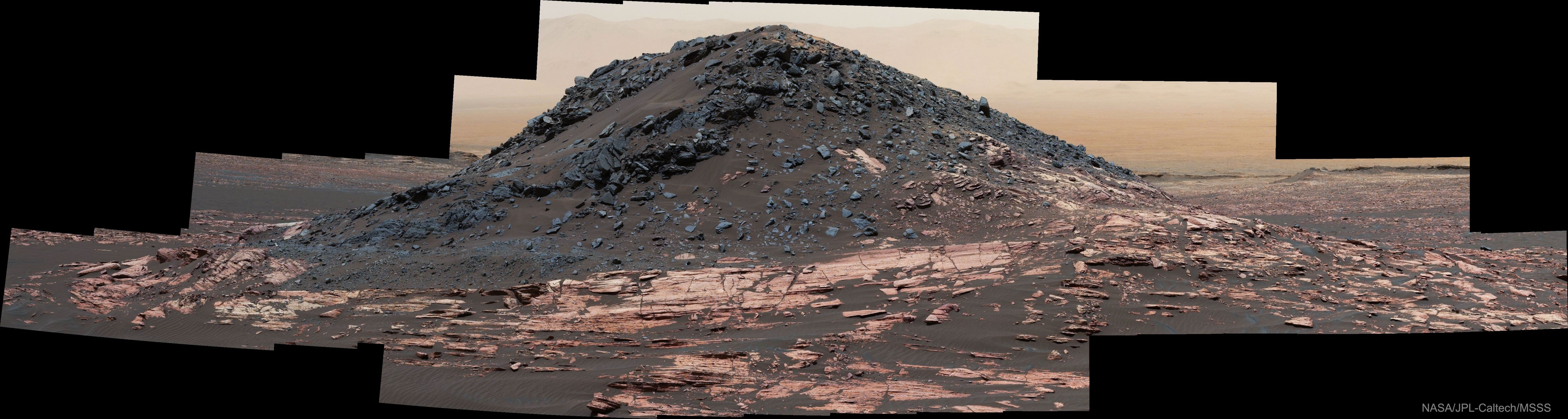 What created this unusual hill on Mars? Its history has become a topic of research, but its shape and two-tone structure makes it one of the more unusual hills that the robotic Curiosity rover on Mars has rolled near.  Dubbed Ireson Hill, the mound rises about 5 meters high and spans about 15 meters across.  Ireson Hill is located on the Bagnold Dune field on the slope of Mount Sharp in Gale Crater on Mars. The featured 41-image panorama has been horizontally compressed to include the entire hill. The image was taken on February 2 and released last week. Because Mars is moving behind the Sun as seen from the Earth, NASA will soon stop sending commands to its Martian orbiters and rovers until about August 1.    Explore the Universe: Random APOD Generator
