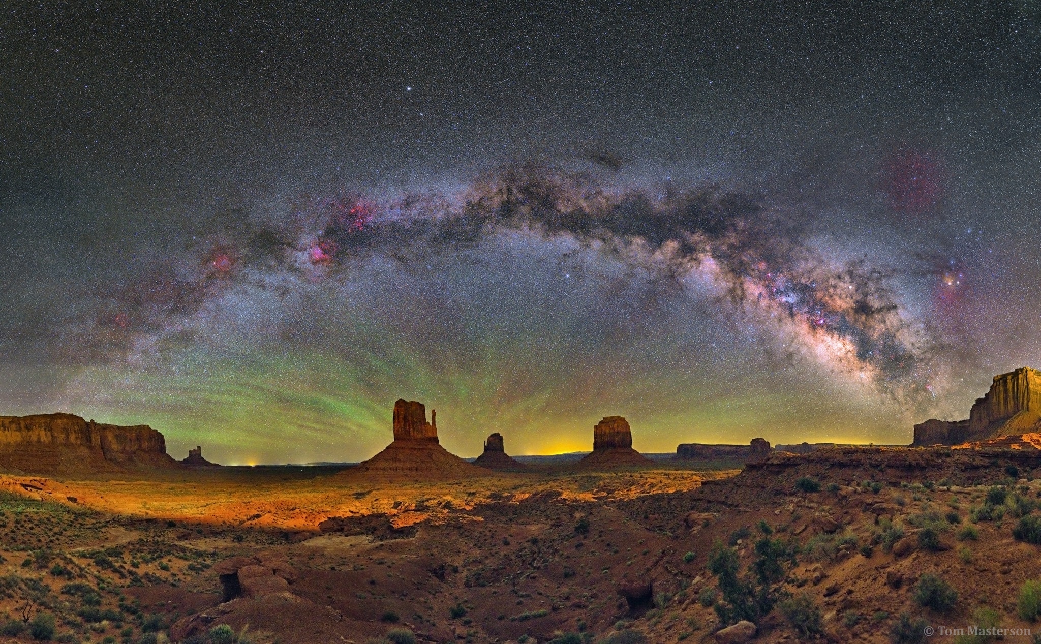 You don't have to be at Monument Valley to see the Milky Way arc across the sky like this -- but it helps. Only at Monument Valley USA would you see a picturesque foreground that includes these iconic rock peaks called buttes. Buttes are composed of hard rock left behind after water has eroded away the surrounding soft rock.  In the featured image taken a month ago, the closest butte on the left and the butte to its right are known as the Mittens, while Merrick Butte can be seen farther to the right. Green airglow fans up from the horizon.  High overhead stretches a band of diffuse light that is the central disk of our spiral Milky Way Galaxy. The band of the Milky Way can be spotted by almost anyone on almost any clear night when far enough from a city and surrounding bright lights, but a sensitive digital camera is needed to capture these colors in a dark night sky.