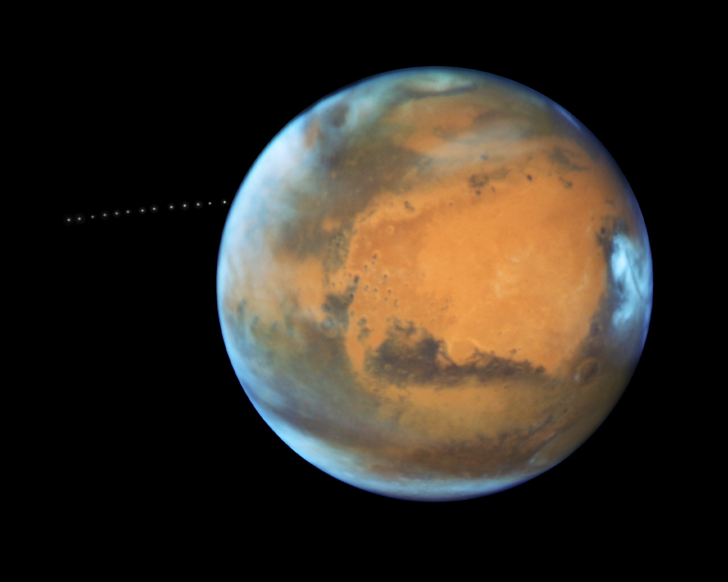 A tiny moon with a scary name, Phobos emerges from behind the Red Planet in this timelapse sequence from the Earth-orbiting Hubble Space Telescope. Over 22 minutes the 13 separate exposures were captured near the 2016 closest approach of Mars to planet Earth. Martians have to look to the west to watch Phobos rise, though. The small moon is closer to its parent planet than any other moon in the Solar System, about 3,700 miles (6,000 kilometers) above the Martian surface. It completes one orbit in just 7 hours and 39 minutes. That's faster than a Mars rotation, which corresponds to about 24 hours and 40 minutes. So on Mars, Phobos can be seen to rise above the western horizon 3 times a day. Still, Phobos is doomed.