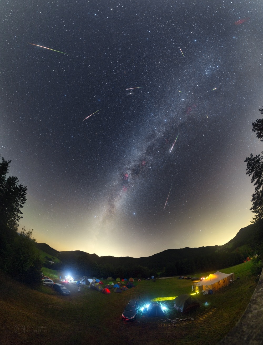This weekend, meteors will rain down near the peak of the annual Perseid Meteor Shower. Normally bright and colorful, the Perseid shower meteors are produced by dust swept up by planet Earth from the orbit of Comet Swift-Tuttle. They streak from a radiant in Perseus, above the horizon in clear predawn skies. Despite interfering light from August's waning gibbous moon, this year's Perseids will still be enjoyable, especially if you can find yourself in an open space, away from city lights, and in good company. Frames used in this composite view capture bright Perseid meteors from the 2016 meteor shower set against a starry background along the Milky Way, with even the faint Andromeda Galaxy just above center. In the foreground, astronomers of all ages have gathered on a hill above the Slovakian village of Vrchtepla.
