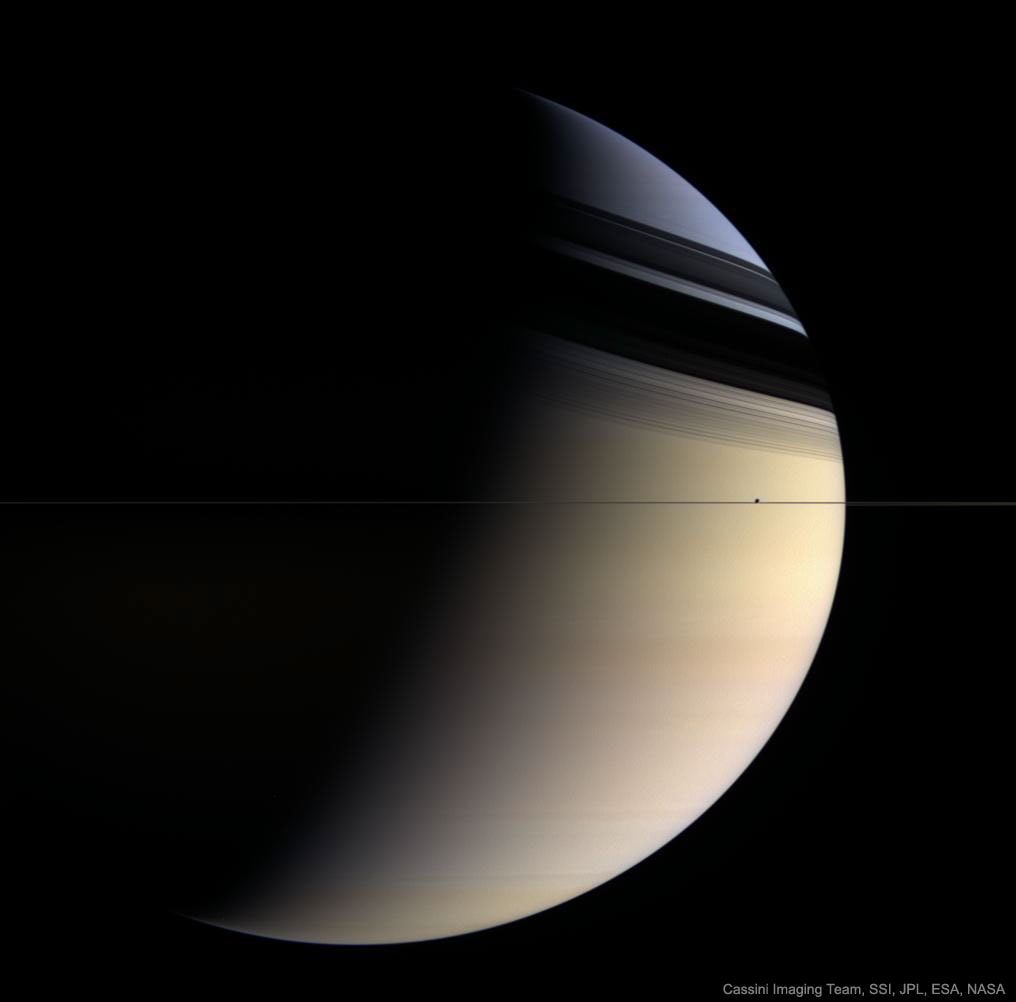 Why is Saturn partly blue?  The featured picture of Saturn approximates what a human would see if hovering close to the giant ringed world.   The image was taken in 2006 March by the robot Cassini spacecraft now orbiting Saturn.  Here Saturn's majestic rings appear directly only as a thin vertical line.  The rings show their complex structure in the dark shadows they create on the image left.   Saturn's fountain moon Enceladus, only about 500 kilometers across, is seen as the bump in the plane of the rings.  The northern hemisphere of Saturn can appear partly blue for the same reason that Earth's skies can appear blue -- molecules in the cloudless portions of both planet's atmospheres are better at scattering blue light than red.  When looking deep into Saturn's clouds, however, the natural gold hue of Saturn's clouds becomes dominant.   It is not known why southern Saturn does not show the same blue hue -- one hypothesis holds that clouds are higher there.   It is also not known why Saturn's clouds are colored gold. Next month, Cassini will end its mission with a final dramatic dive into Saturn's atmosphere.   Eclipses 2017: Memorable images submitted to APOD -- please "Like" your favorites.