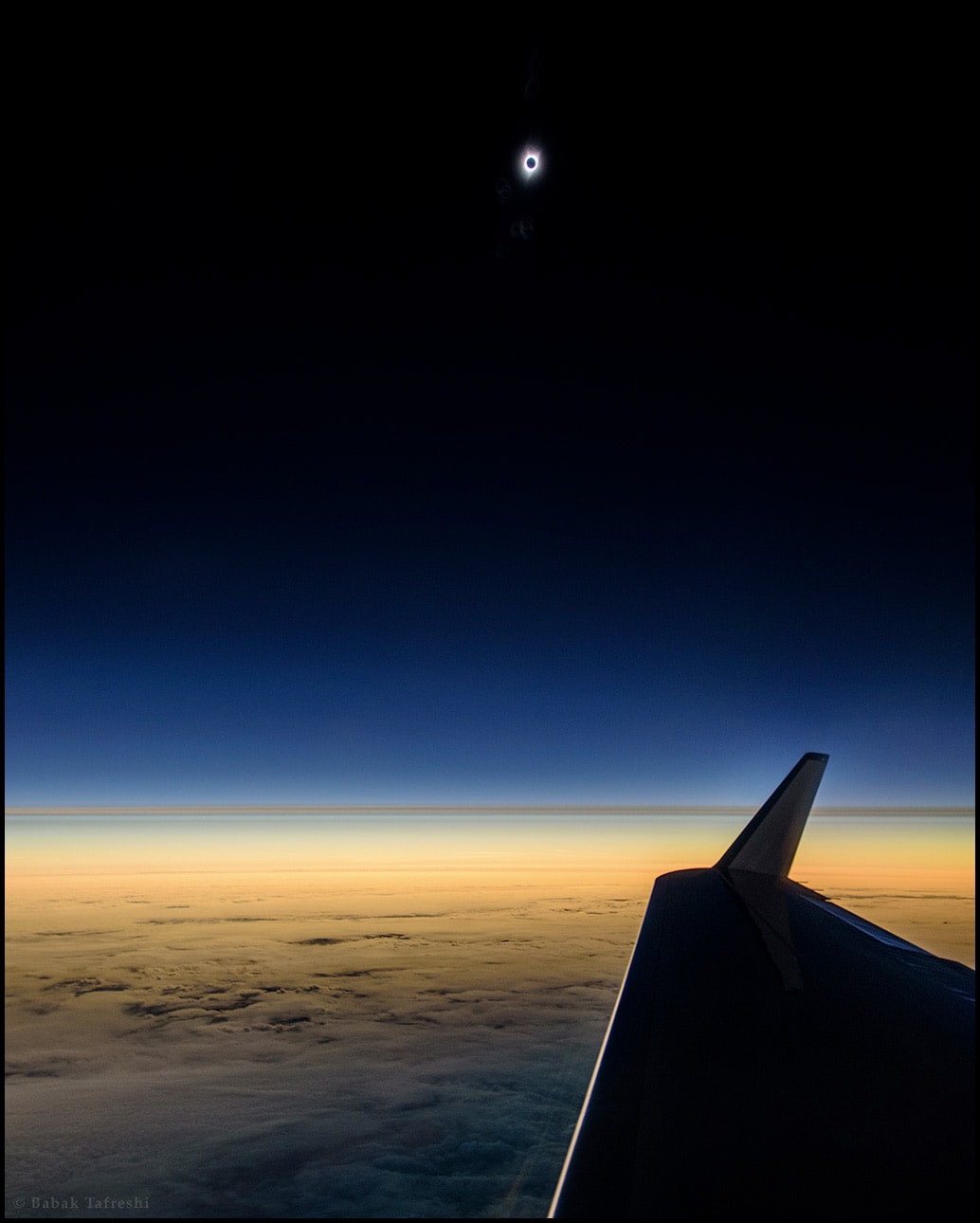 Making landfall in Oregon, the Moon's dark umbral shadow toured the United States on August 21. Those gathered along its coast to coast path were witness to a total eclipse of the Sun, possibly the most widely shared celestial event in history. But first, the Moon's shadow touched the northern Pacific and raced eastward toward land. This dramatic snapshot was taken while crossing the shadow path 250 miles off the Oregon coast, 45,000 feet above the cloudy northern Pacific. Though from a shorter totality, it captures the eclipse before it could be seen from the US mainland. With the eclipsed Sun not far above, beautiful colors appear along the eastern horizon giving way to a clear, pitch-black, stratospheric sky in the shadow of the Moon.
