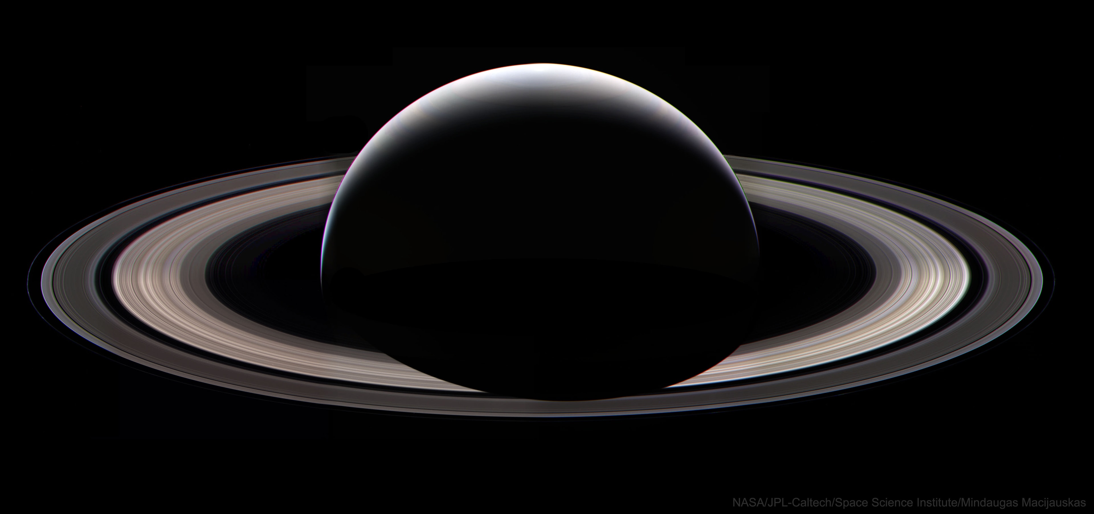 How should Cassini say farewell to Saturn?  Three days before plunging into Saturn's sunny side, the robotic Cassini spacecraft swooped far behind Saturn's night side with cameras blazing. Thirty-six of these images have been merged -- by an alert and adept citizen scientist -- into a last full-ring portrait of Cassini's home planet for the past 13 years. The Sun is just above the frame, causing Saturn to cast a dark shadow onto its enormous rings. This shadow position cannot be imaged from Earth and will not be visible again until another Earth-launched spaceship visits the ringed giant.  Data and images from Cassini's mission-ending dive into Saturn's atmosphere on September 15 continue to be analyzed.   Almost Hyperspace: Random APOD Generator