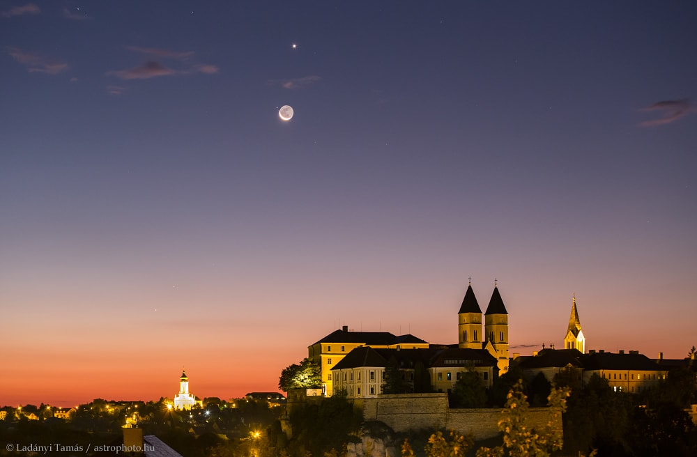 The Moon, three planets, and a bright star gathered near the ecliptic plane in the September 18 morning sky over Veszprem Castle, Hungary. In this twilight skyscape, Mercury and Mars still shine close to the eastern horizon, soon to disappear in the glare of the Sun. Regulus, alpha star of the constellation Leo, is the bright point next to a waning crescent Moon, with brilliant Venus near the top of the frame. The beautiful morning conjunction of Moon, planets, and bright star could generally be followed by early morning risers all around planet Earth. But remarkably, the Moon also occulted, or passed directly in front of, Regulus and each of the three planets within 24 hours, all on September 18 UT. Visible from different locations, timing and watching the lunar occultations was much more difficult though, and mostly required viewing in daytime skies.