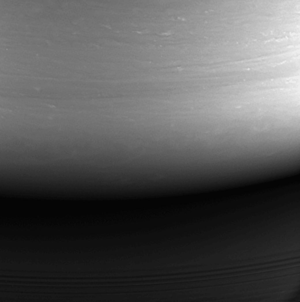 As planned, the Cassini spacecraft impacted the upper atmosphere of Saturn on September 15, after a 13 year long exploration of the Saturnian System. With spacecraft thrusters firing until the end, its atmospheric entry followed an unprecedented series of 22 Grand Finale dives between Saturn and rings. Cassini's final signal took 83 minutes to reach planet Earth and the Deep Space Network antenna complex in Canberra Australia where loss of contact with the spacecraft was recorded at 11:55 UT. For the spacecraft, Saturn was bright and the Sun was overhead as it plowed into the gas giant planet's swirling cloud tops at about 70,000 miles (113,000 kilometers) per hour. But Cassini's final image shows the impact site hours earlier and still on the planet's night side, the cloud tops illuminated by ringlight, sunlight reflected from Saturn's rings.