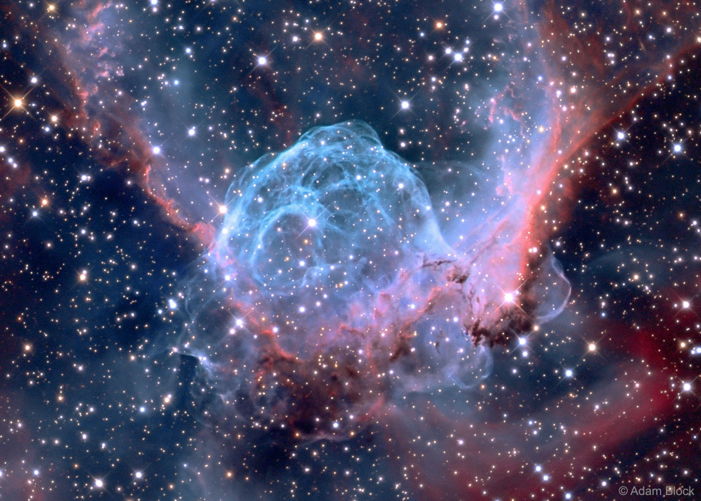 This helmet-shaped cosmic cloud with wing-like appendages is popularly called Thor's Helmet. Heroically sized even for a Norse god, Thor's Helmet spans about 30 light-years across. In fact, the helmet is more like an interstellar bubble, blown as a fast wind -- from the bright star near the center of the bubble's blue-hued region -- sweeps through a surrounding molecular cloud. This star, a Wolf-Rayet star, is a massive and extremely hot giant star thought to be in a brief, pre-supernova stage of evolution. Cataloged as NGC 2359, the emission nebula is located about 12,000 light-years away toward the constellation of the Big Dog (Canis Major). The sharp image, made using broadband and narrowband filters, captures striking details of the nebula's filamentary gas and dust structures. The blue color originates from strong emission from  oxygen atoms in the nebula.   Follow APOD on: Facebook,  Google Plus,  Instagram, or Twitter