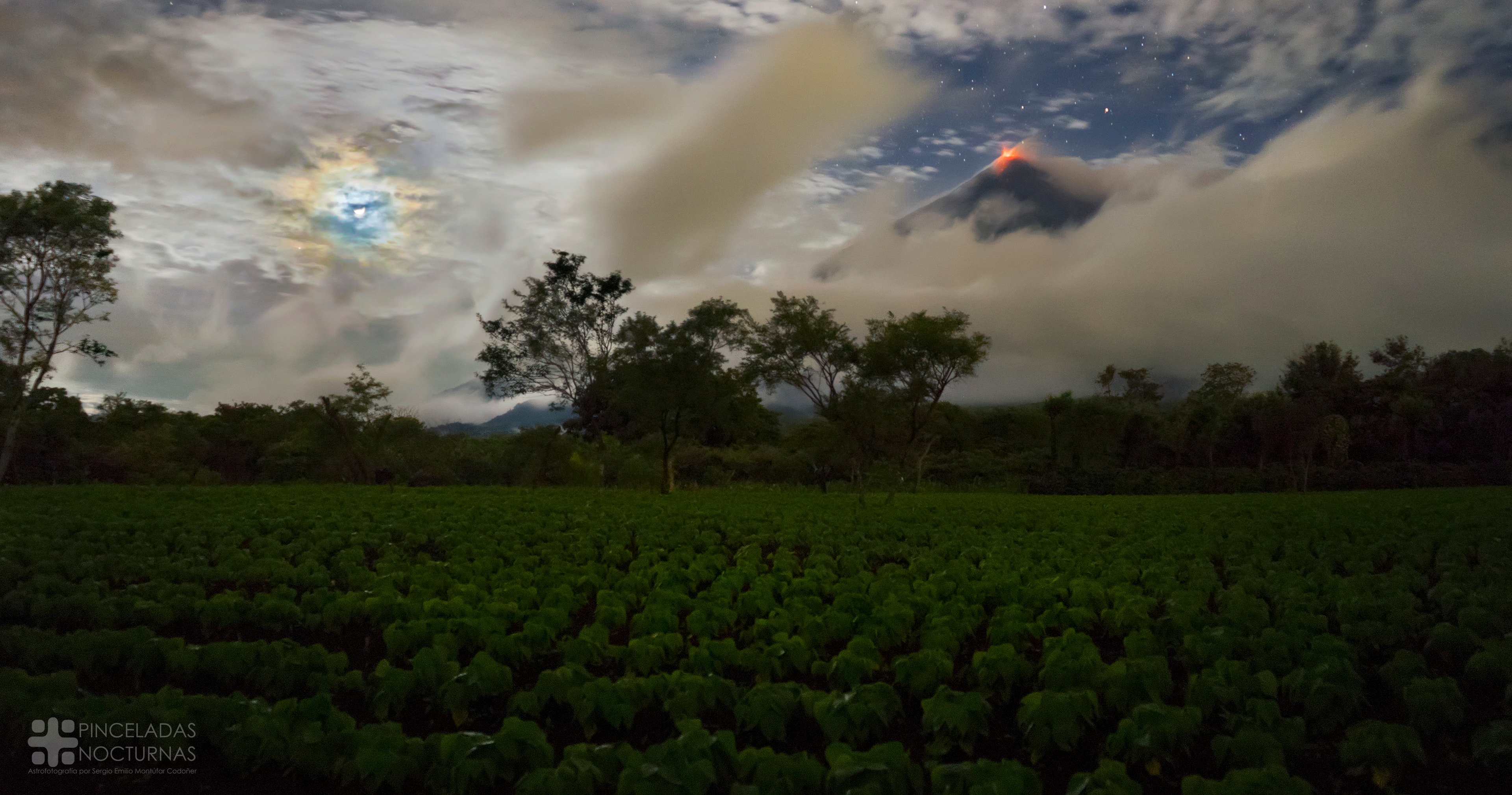 What's happening on the horizon? The horizon itself, past a spinach field in Guatemala, shows not only trees but a large volcano: the Volc�n de Fuego (Volcano of Fire). The red glow at the top of the volcano is hot lava. But your eye may also be drawn to the blue circle above the horizon on the left. This circle surrounds the Moon and, together with other colors, is called a corona. A corona is caused by diffraction of light -- here moonlight -- by small water droplets in the Earth's intervening atmosphere. A break in the clouds on the right shows stars and even the planet Saturn far beyond the volcano.  Although Volc�n de Fuego frequently undergoes low-level activity, the astrophotographer considered himself lucky to capture the scene just during an explosive eruption in late September.    Follow APOD on: Facebook,  Google Plus,  Instagram, or Twitter