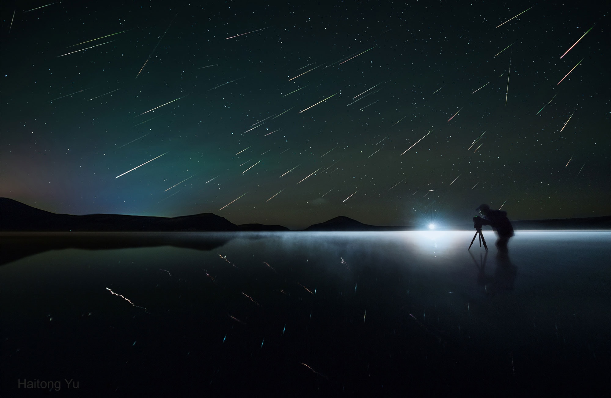 Did you ever get caught in a meteor shower? If yes, then every minute or so the sky sparked with fleeting flashes of light. This was the fate of the pictured astrophotographer during last year's Perseids meteor shower. During the featured three-hour image composite, about 90 Perseids rained down above Lake Duolun of Inner Mongolia, China. If you trace back the meteor streaks, you will find that most of them appear to radiate from a single constellation -- in this case Perseus. In fact, you can even tell which meteors are not Perseids because they track differently. Tonight promises to be another good night to get caught in a meteor shower because it is the peak for the Geminids. Gemini, the shower radiant, should rise shortly after sunset and be visible most of the night.   Free APOD Lectures: January 5 in NYC & January 9 in DC