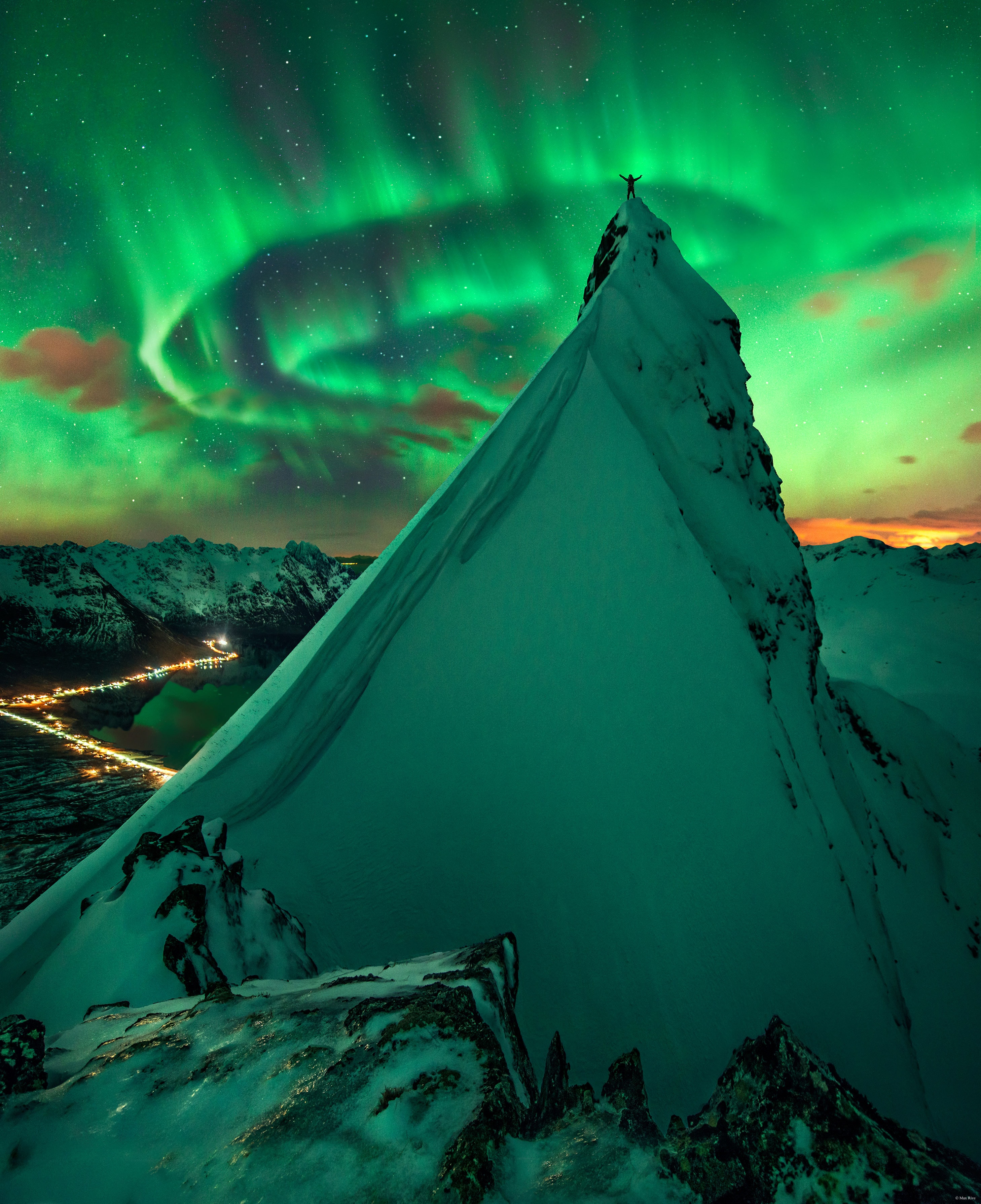 Raise your arms if you see an aurora. With those instructions, two nights went by with, well, clouds -- mostly. On the third night of returning to same peaks, though, the sky not only cleared up but lit up with a spectacular auroral display. Arms went high in the air, patience and experience paid off, and the creative featured image was captured as a composite from three separate exposures. The setting is a summit of the Austnesfjorden fjord close to the town of Svolvear on the Lofoten islands in northern Norway. The time was early 2014. Although our Sun is nearing Solar Minimum and hence showing relatively little surface activity, holes in the upper corona have provided some nice auroral displays over the last few months.   Follow APOD on: Facebook,  Google Plus,  Instagram, Twitter or Snapchat