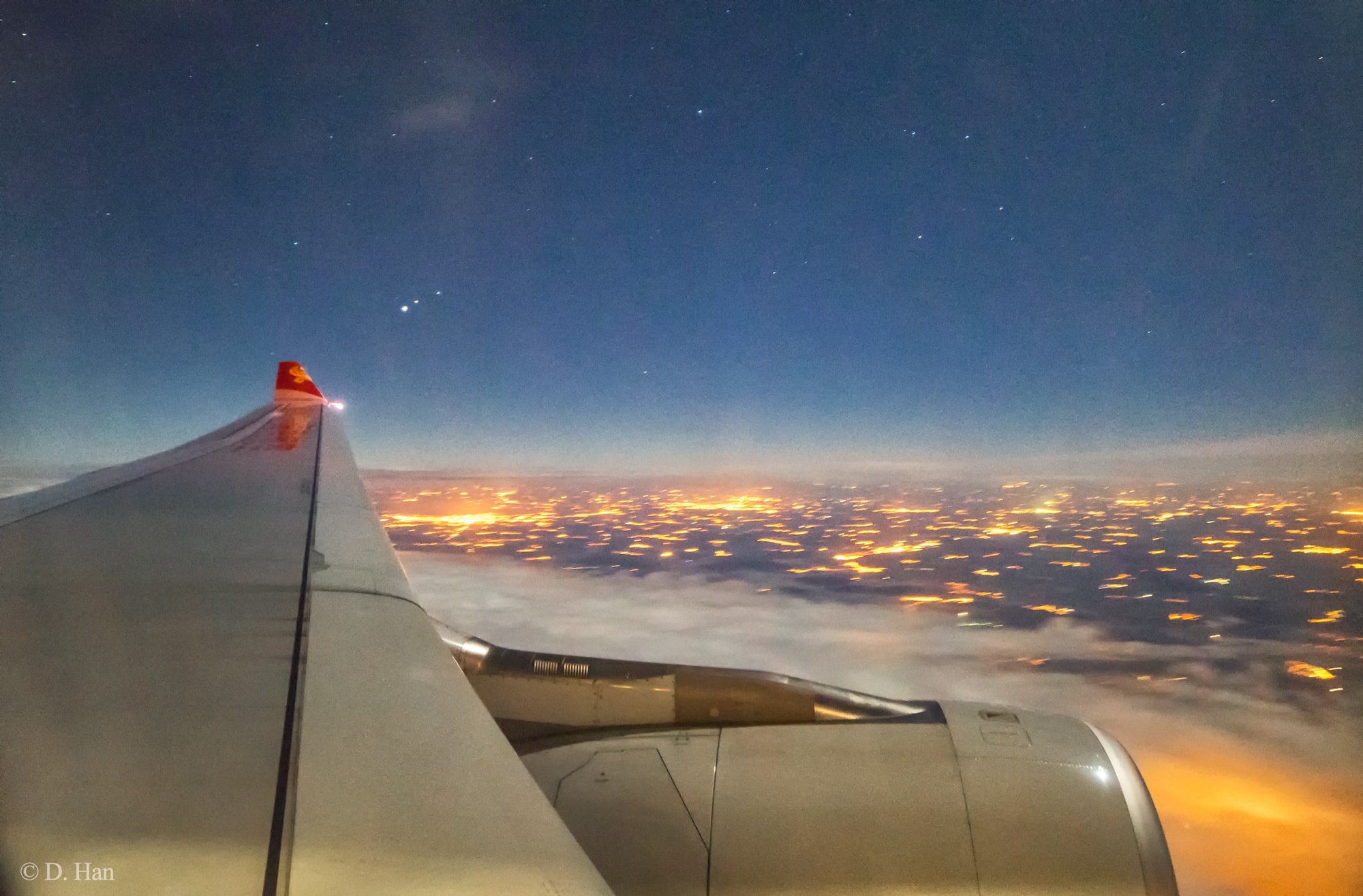 Lately, bright Jupiter and fainter Mars have been easy to spot for early morning skygazers. Before dawn on January 7 the two naked-eye planets will reach a close conjunction near the horizon, only 1/4 degree apart in predawn eastern skies. That apparent separation corresponds to about half the angular diameter of a Full Moon. Just off the wing of a high-flying aircraft in this snapshot from early morning January 5, Jupiter (left) and Mars (middle) are also lined-up with the well-balanced Zubenelgenubi (right), alpha star of the constellation Libra. Below are lights from central Europe near Prague, Czech Republic, planet Earth.