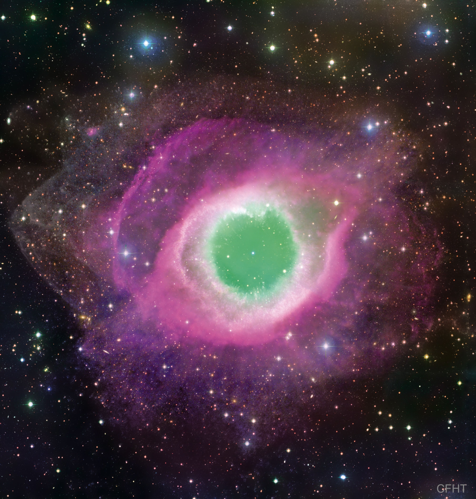 Will our Sun look like this one day?  The Helix Nebula is one of brightest and closest examples of a planetary nebula, a gas cloud created at the end of the life of a Sun-like star. The outer gasses of the star expelled into space appear from our vantage point as if we are looking down a helix. The remnant central stellar core, destined to become a white dwarf star, glows in light so energetic it causes the previously expelled gas to fluoresce. The Helix Nebula, given a technical designation of NGC 7293, lies about 700 light-years away towards the constellation of the Water Bearer (Aquarius) and spans about 2.5 light-years. The featured picture was taken with the Canada-France-Hawaii Telescope (CFHT) located atop a dormant volcano in Hawaii, USA. A close-up of the inner edge of the Helix Nebula shows complex gas knots of unknown origin.   Free APOD Lectures: January 5 in NYC & January 9 in DC