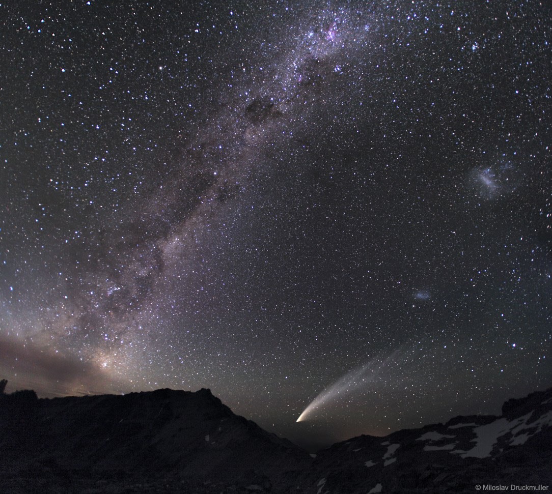Diffuse starlight and dark nebulae along the southern Milky Way arc over the horizon and sprawl diagonally through this gorgeous nightscape. The breath-taking mosaic spans a wide 100 degrees, with the rugged terrain of the Patagonia, Argentina region in the foreground. Along with the insider's view of our own galaxy, the image features our outside perspective on two irregular satellite galaxies - the Large and Small Magellanic Clouds. The scene also captures the broad tail and bright coma of Comet McNaught, the Great Comet of 2007.   Follow APOD on: Facebook,  Google Plus,  Instagram, or Twitter