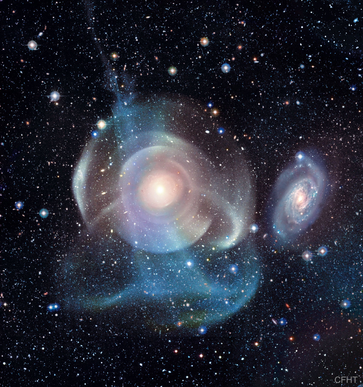 What's happening to galaxy NGC 474? The multiple layers of emission appear strangely complex and unexpected given the relatively featureless appearance of the elliptical galaxy in less deep images. The cause of the shells is currently unknown, but possibly tidal tails related to debris left over from absorbing numerous small galaxies in the past billion years. Alternatively the shells may be like ripples in a pond, where the ongoing collision with the spiral galaxy just above NGC 474 is causing density waves to ripple through the galactic giant. Regardless of the actual cause, the featured image dramatically highlights the increasing consensus that at least some elliptical galaxies have formed in the recent past, and that the outer halos of most large galaxies are not really smooth but have complexities induced by frequent interactions with -- and accretions of -- smaller nearby galaxies. The halo of our own Milky Way Galaxy is one example of such unexpected complexity. NGC 474 spans about 250,000 light years and lies about 100 million light years distant toward the constellation of the Fish (Pisces).