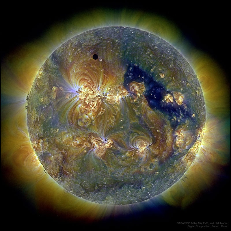An unusual type of solar eclipse occurred in 2012.  Usually it is the Earth's Moon that eclipses the Sun.  That year, most unusually, the planet Venus took a turn.  Like a solar eclipse by the Moon, the phase of Venus became a continually thinner crescent as Venus became increasingly better aligned with the Sun.  Eventually the alignment became perfect and the phase of Venus dropped to zero.  The dark spot of Venus crossed our parent star.  The situation could technically be labeled a Venusian annular eclipse with an extraordinarily large ring of fire.  Pictured here during the occultation, the Sun was imaged in three colors of ultraviolet light by the Earth-orbiting Solar Dynamics Observatory, with the dark region toward the right corresponding to a coronal hole. Hours later, as Venus continued in its orbit, a slight crescent phase appeared again.  The next Venusian transit across the Sun will occur in 2117.