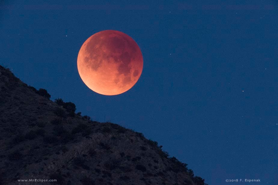 Near the closest point in its orbit, the second Full Moon of the month occurred on January 31. So did the first Total Lunar Eclipse of 2018, as the Moon slid through planet Earth's shadow. In a postcard from planet Earth, this telescopic snapshot captures the totally eclipsed Moon as it set above the western horizon and the Chiricahua Mountains of southern Arizona. The Moon's evocative reddened hue is due to sunlight scattered into the shadow. Still, the planet's shadow visibly grows darker near the center, toward the top of the lunar disk.