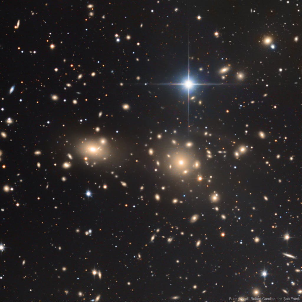 Almost every object in the above photograph is a galaxy.  The Coma Cluster of Galaxies pictured here is one of the densest clusters known - it contains thousands of galaxies.  Each of these galaxies houses billions of stars - just as our own Milky Way Galaxy does.  Although nearby when compared to most other clusters, light from the Coma Cluster still takes hundreds of millions of years to reach us.  In fact, the Coma Cluster is so big it takes light millions of years just to go from one side to the other.  Most galaxies in Coma and other clusters are  ellipticals, while most galaxies outside of clusters are spirals.  The nature of Coma's X-ray emission is still being investigated.