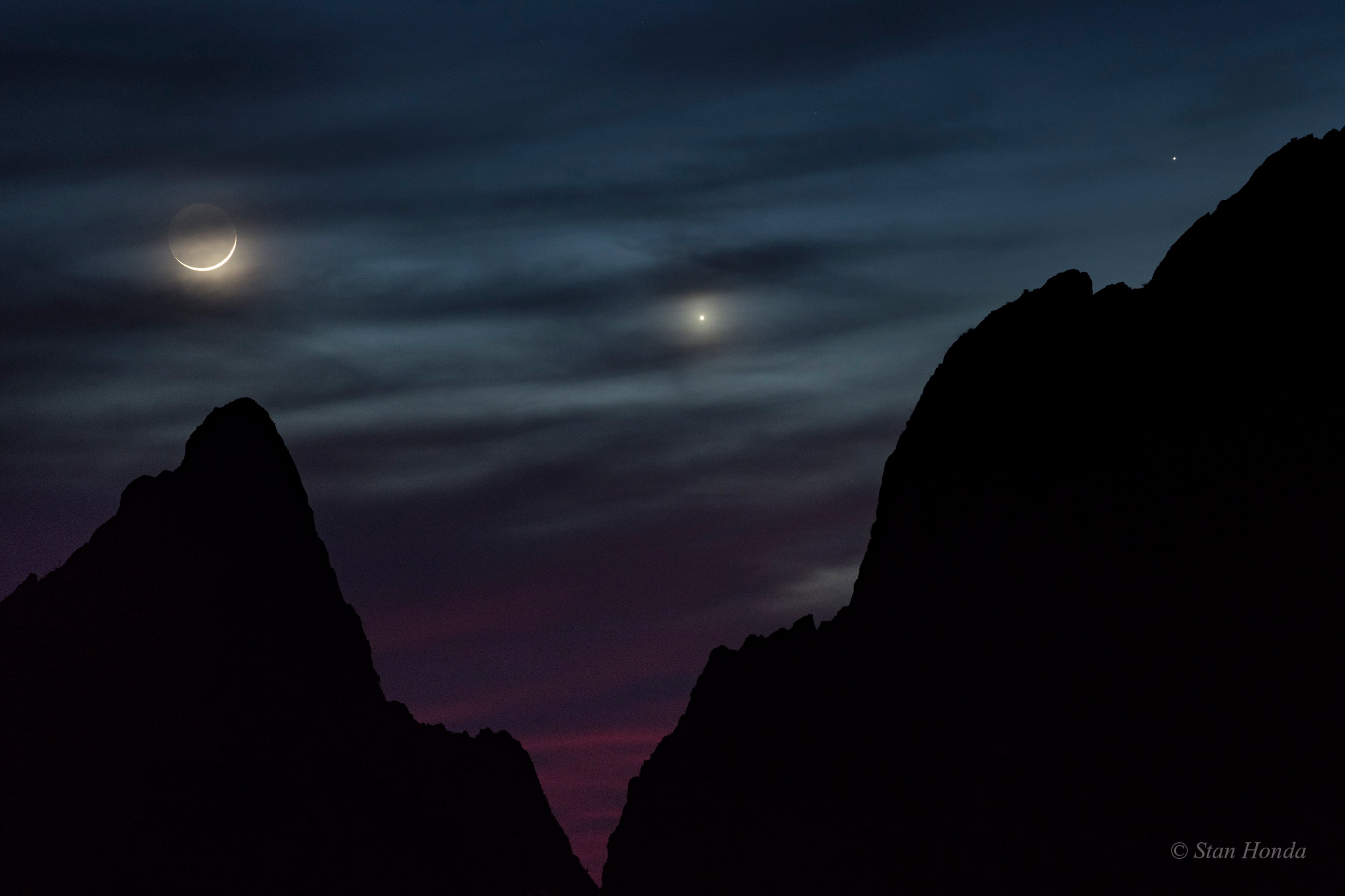 A slender crescent Moon and inner planets Venus and Mercury never wander far from the Sun in planet Earth's skies. In the fading evening twilight of March 18, they line up near the western horizon in this atmospheric skyscape. While the celestial scene was enjoyed around the world, this photo captures the trio, with fainter Mercury at the far right, above the crags of Big Bend National Park in southwest Texas. Tonight the Moon will be full though, and rise opposite the Sun. Look for it high in the sky at midnight, near bright star Spica.
