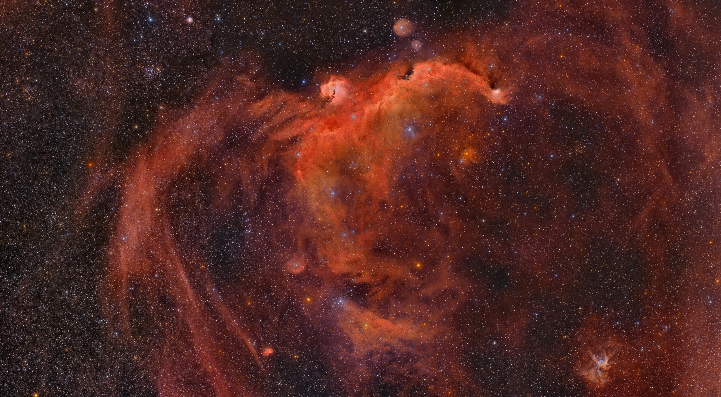 Seen as a seagull and a duck, these nebulae are not the only cosmic clouds to evoke images of flight. But both are winging their way across this broad celestial landscape, spanning almost 7 degrees across planet Earth's night sky toward the constellation Canis Major. The expansive Seagull (top center) is itself composed of two major cataloged emission nebulae. Brighter NGC 2327 forms the head with the more diffuse IC 2177 as the wings and body. Impressively, the Seagull's wingspan would correspond to about 250 light-years at the nebula's estimated distance of 3,800 light-years. At the lower right, the Duck appears much more compact and would span only about 50 light-years given its 15,000 light-year distance estimate. Blown by energetic winds from an extremely massive, hot star near its center, the Duck nebula is cataloged as NGC 2359. Of course, the Duck's thick body and winged appendages also lend it the slightly more dramatic popular moniker, Thor's Helmet.