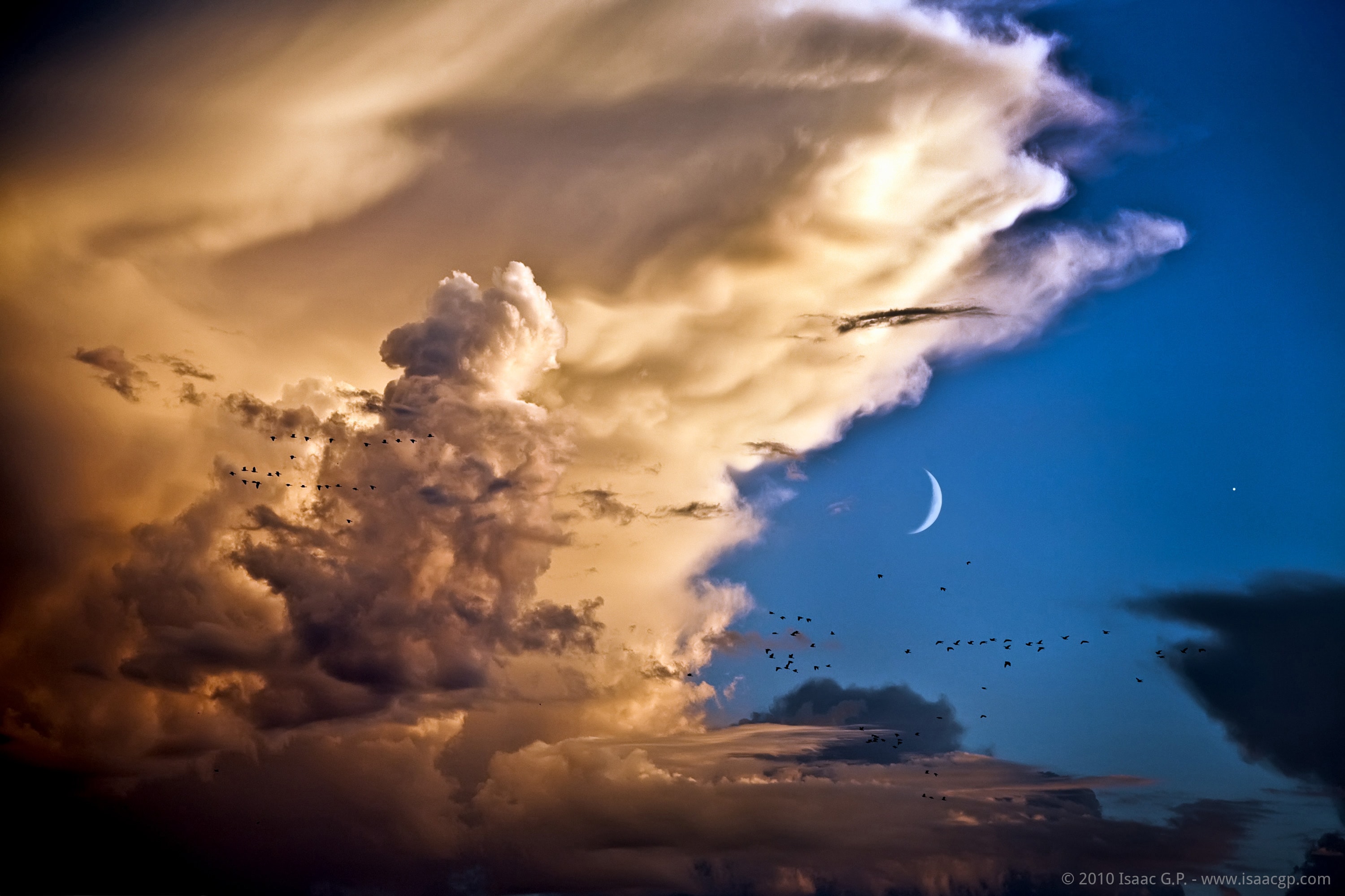 Sometimes the sky above can become quite a show. In early September of 2010, for example, the Moon and Venus converged, creating quite a sight by itself for sky enthusiasts around the globe.  From some locations, though, the sky was even more picturesque. In the featured image taken in Spain, a crescent Moon and the planet Venus, on the far right, were captured during sunset posing against a deep blue sky.  In the foreground, dark storm clouds loom across the image bottom, while a white anvil cloud shape appears above. Black specks dot the frame, caused by a flock of birds taking flight. Very soon after this picture was taken, however, the birds passed by, the storm ended, and Venus and the Moon set.  Bright Venus is again visible just after sunset this month (2018 March) and will appear quite near Mercury tonight and the rest of this week.