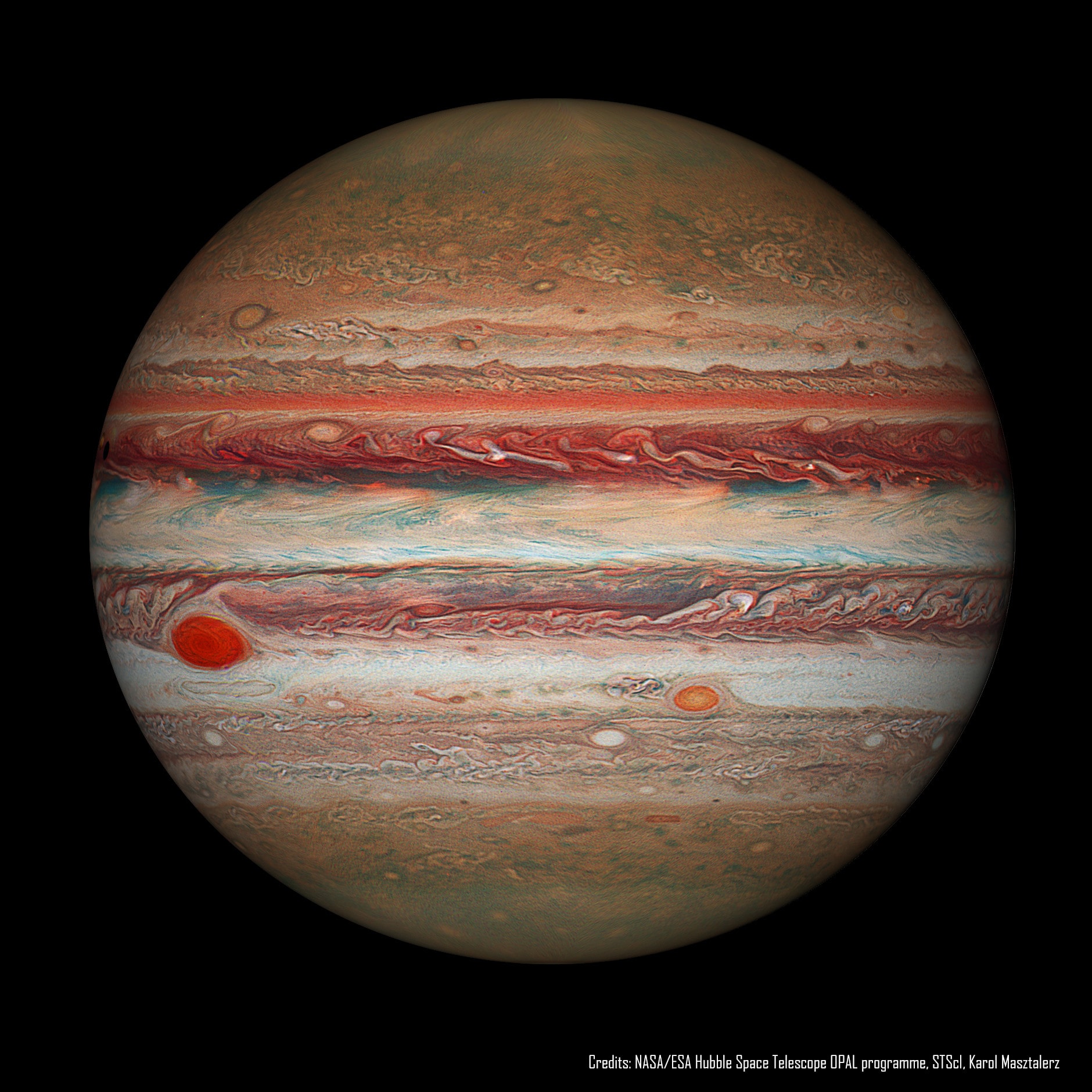 What will become of Jupiter's Great Red Spot?  Gas giant Jupiter is the solar system's largest world with about 320 times the mass of planet Earth. Jupiter is home to one of the largest and longest lasting storm systems known, the Great Red Spot (GRS), visible to the left. The GRS is so large it could swallow Earth, although it has been shrinking.  Comparison with historical notes indicate that the storm spans only about one third of the surface area it had 150 years ago. NASA's Outer Planets Atmospheres Legacy (OPAL) program has been monitoring the storm more recently using the Hubble Space Telescope. The featured Hubble OPAL image shows Jupiter as it appeared in 2016, processed in a way that makes red hues appear quite vibrant. Modern GRS data indicate that the storm continues to constrict its surface area, but is also becoming slightly taller, vertically.  No one knows the future of the GRS, including the possibility that if the shrinking trend continues, the GRS might one day even do what smaller spots on Jupiter have done -- disappear completely.