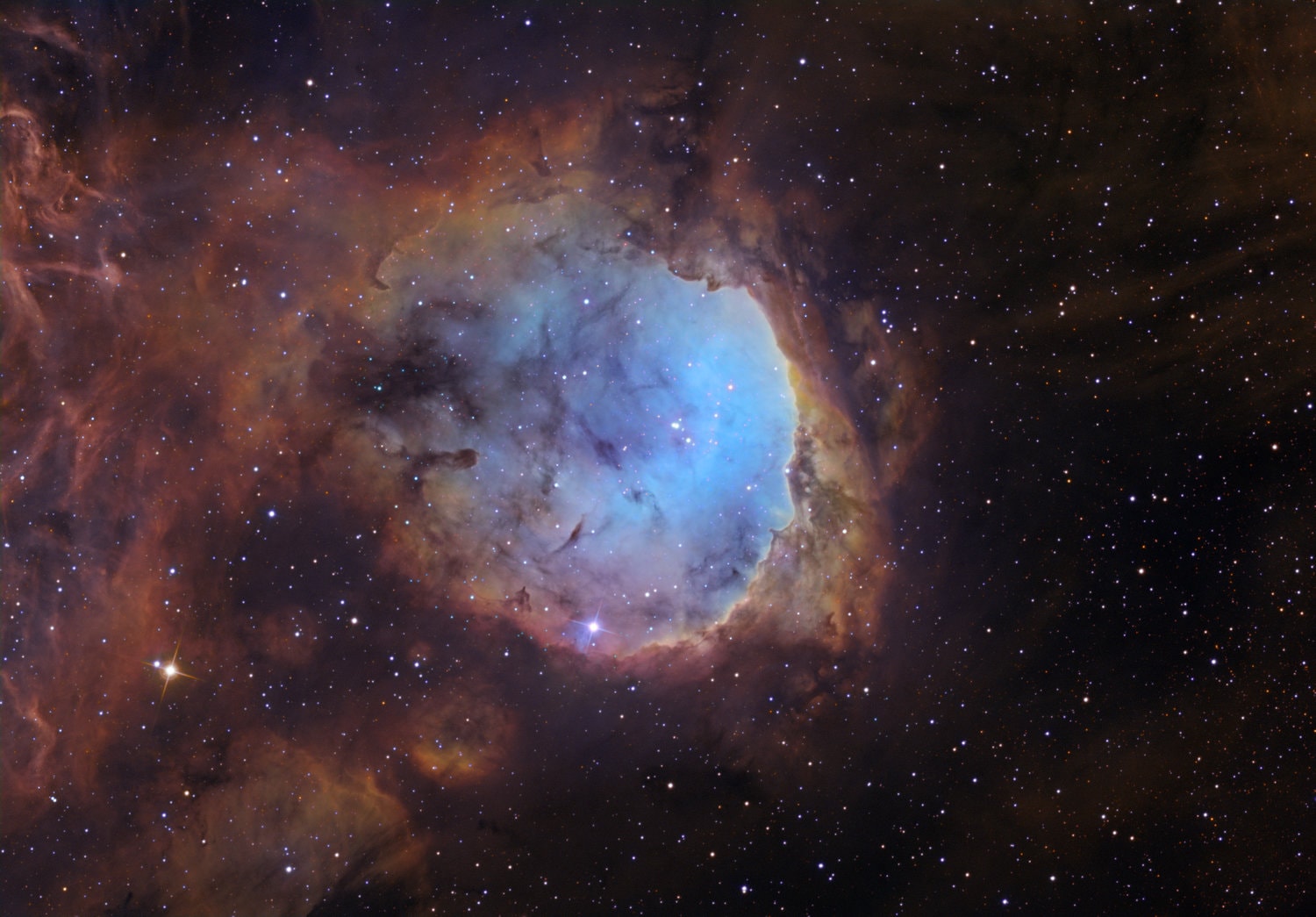 This bright cosmic cloud was sculpted by stellar winds and radiation from the hot young stars of open cluster NGC 3324. With dust clouds in silhouette against its glowing atomic gas, the pocket-shaped star-forming region actually spans about 35 light-years. It lies some 7,500 light-years away toward the nebula rich southern constellation Carina. A composite of narrowband image data, the telescopic view captures the characteristic emission from ionized sulfur, hydrogen, and oxygen atoms mapped to red, green, and blue hues in the popular Hubble Palette. For some, the celestial landscape of bright ridges of emission bordered by cool, obscuring dust along the right side create a recognizable face in profile. The region's popular name is the Gabriela Mistral Nebula for the Nobel Prize winning Chilean poet.