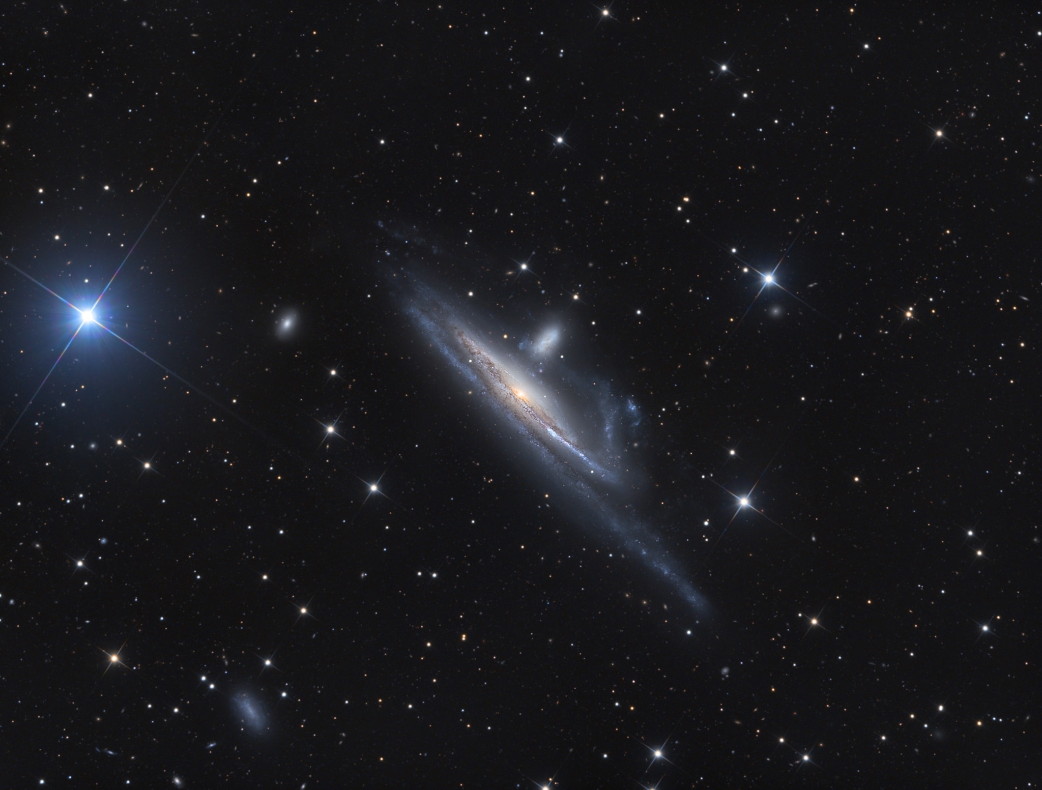 Large galaxies grow by eating small ones. Even our own galaxy practices galactic cannibalism, absorbing small galaxies that get too close and are captured by the Milky Way's gravity. In fact, the practice is common in the universe and illustrated by this striking pair of interacting galaxies from the banks of the southern constellation Eridanus, The River. Located over 50 million light years away, the large, distorted spiral NGC 1532 is seen locked in a gravitational struggle with dwarf galaxy NGC 1531 (right of center), a struggle the smaller galaxy will eventually lose. Seen edge-on, spiral NGC 1532 spans about 100,000 light-years. Nicely detailed in this sharp image, the NGC 1532/1531 pair is thought to be similar to the well-studied system of face-on spiral and small companion known as M51.