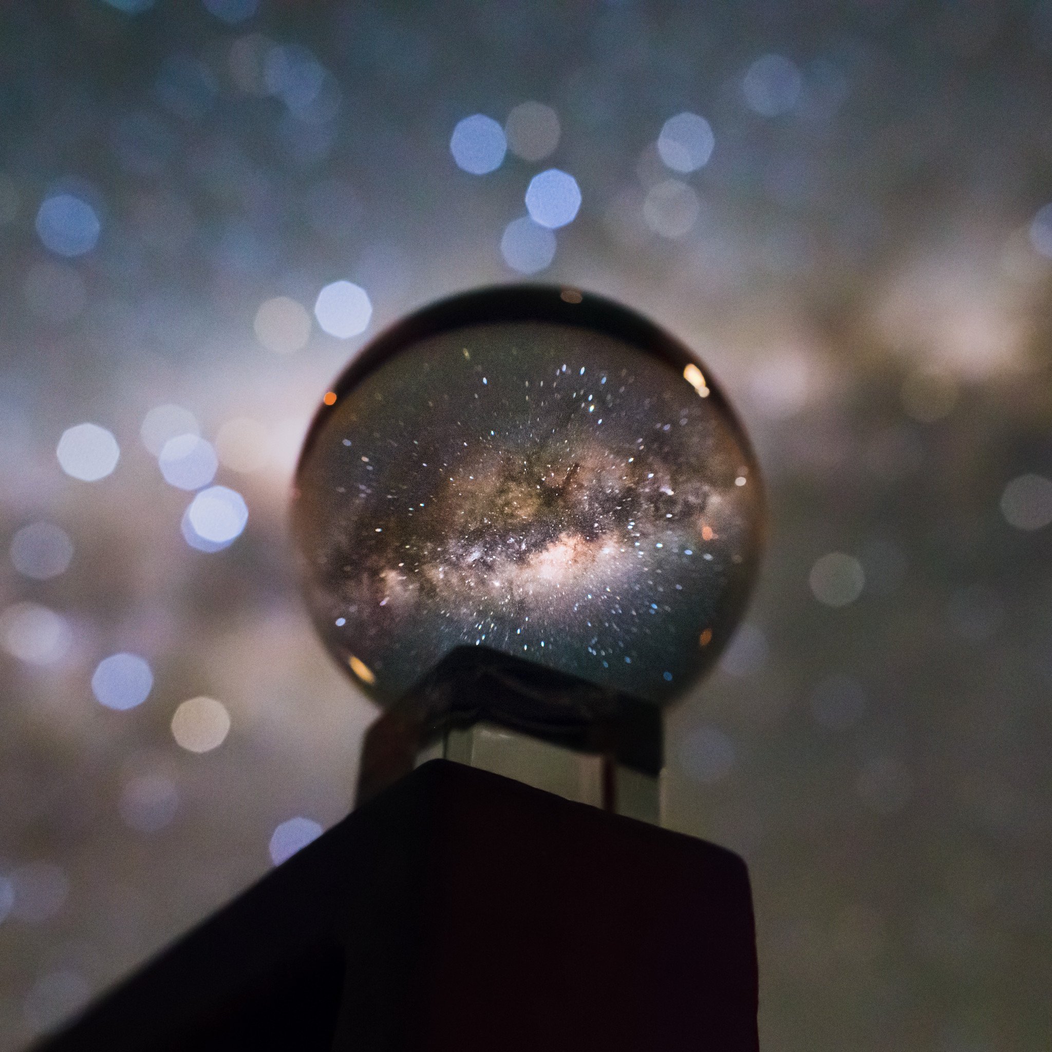A small crystal ball seems to hold a whole galaxy in this creative snapshot. Of course, the galaxy is our own Milky Way. Its luminous central bulge marked by rifts of interstellar dust spans thousands of light-years. On this long southern hemisphere night it filled dark Chilean skies over Paranal Observatory. The single exposure image did not require a Very Large Telescope, though. Experiments with a digital camera on a tripod and crystal ball perched on a handrail outside the Paranal Residencia produced the evocative, cosmic marble portrait of our home galaxy.