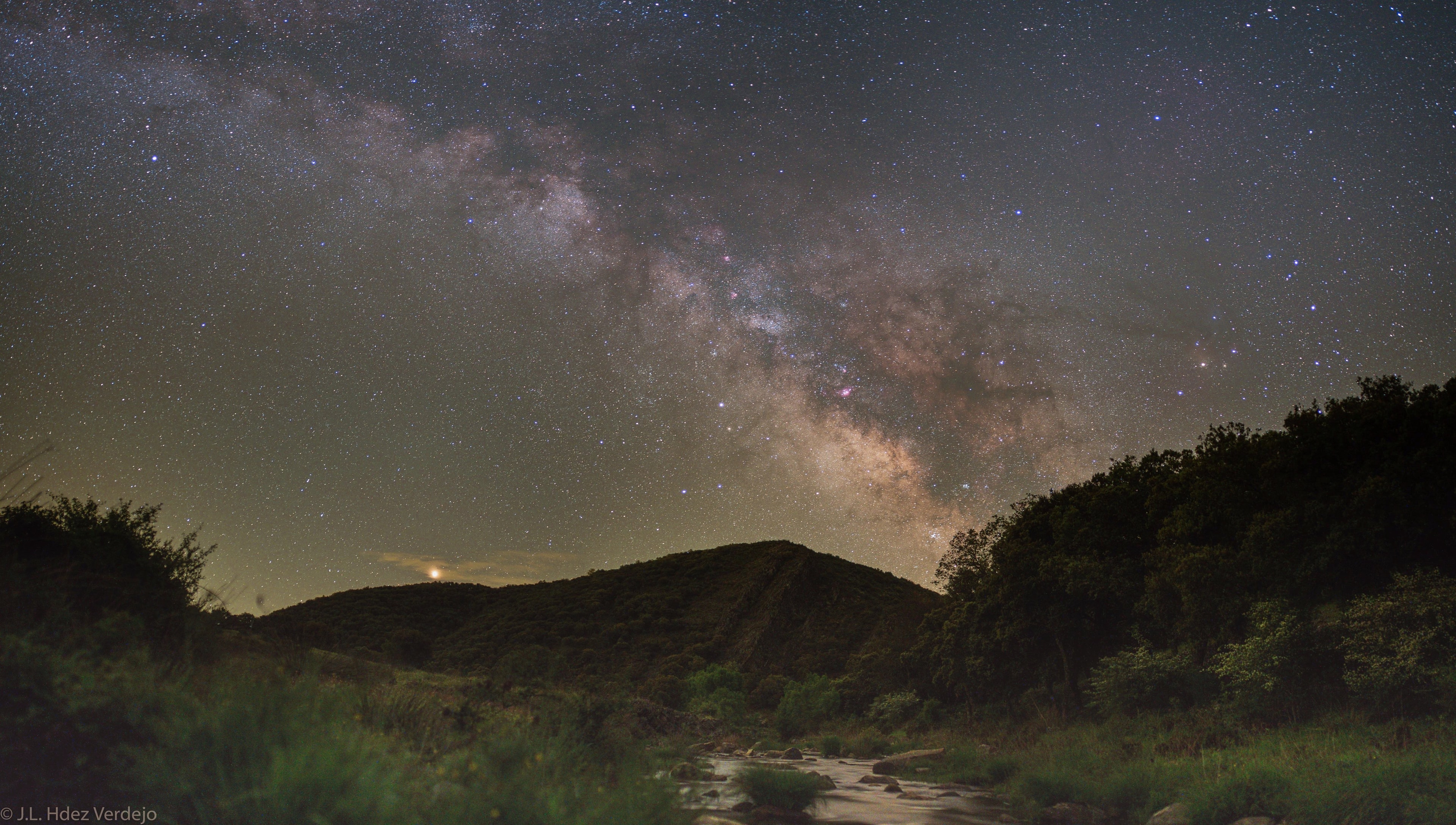 Mars shines brightly now in planet Earth's sky. Seen with a yellowish hue it rises over the hills and far away in this serene night skyscape, a countryside panorama recorded last month from Parque Nacional de Cabaneros in Spain. The Milky Way too extends above the distant hills into a starry sky. Its faint pinkish nebulae, cosmic rifts and rivers of dust are mingled with the pale, diffuse glow of starlight. Mimicking Mars' yellow tint, bright star Antares shines to the right of the central Milky Way starclouds. Of course, CubeSats from Earth are on their way to the Red Planet.