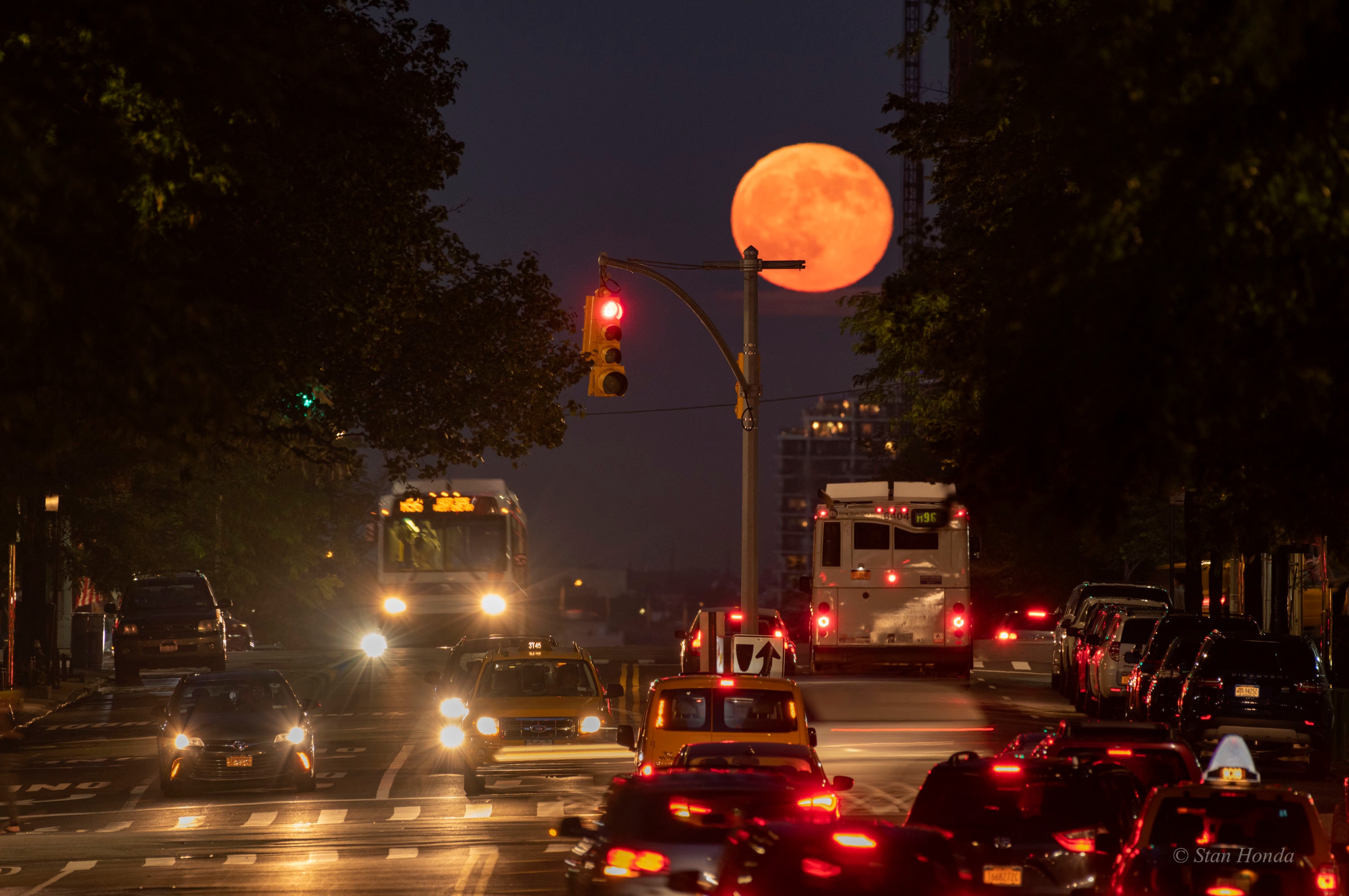 A very full Moon rose over Manhattan's Upper Eastside on June 28, known to some as the Strawberry Moon. Near the horizon, the warm yellow lunar disk was a bit ruffled and dimmed by a long sight-line through dense, hazy atmosphere. Still it fit well with traffic and lights along East 96th street in this urban astroimage. The telephoto shot was (safely) taken from elevated ground looking east-southeast from Central Park, planet Earth. Of course, the East 96th street moon was the closest Full Moon to this year's northern summer solstice.