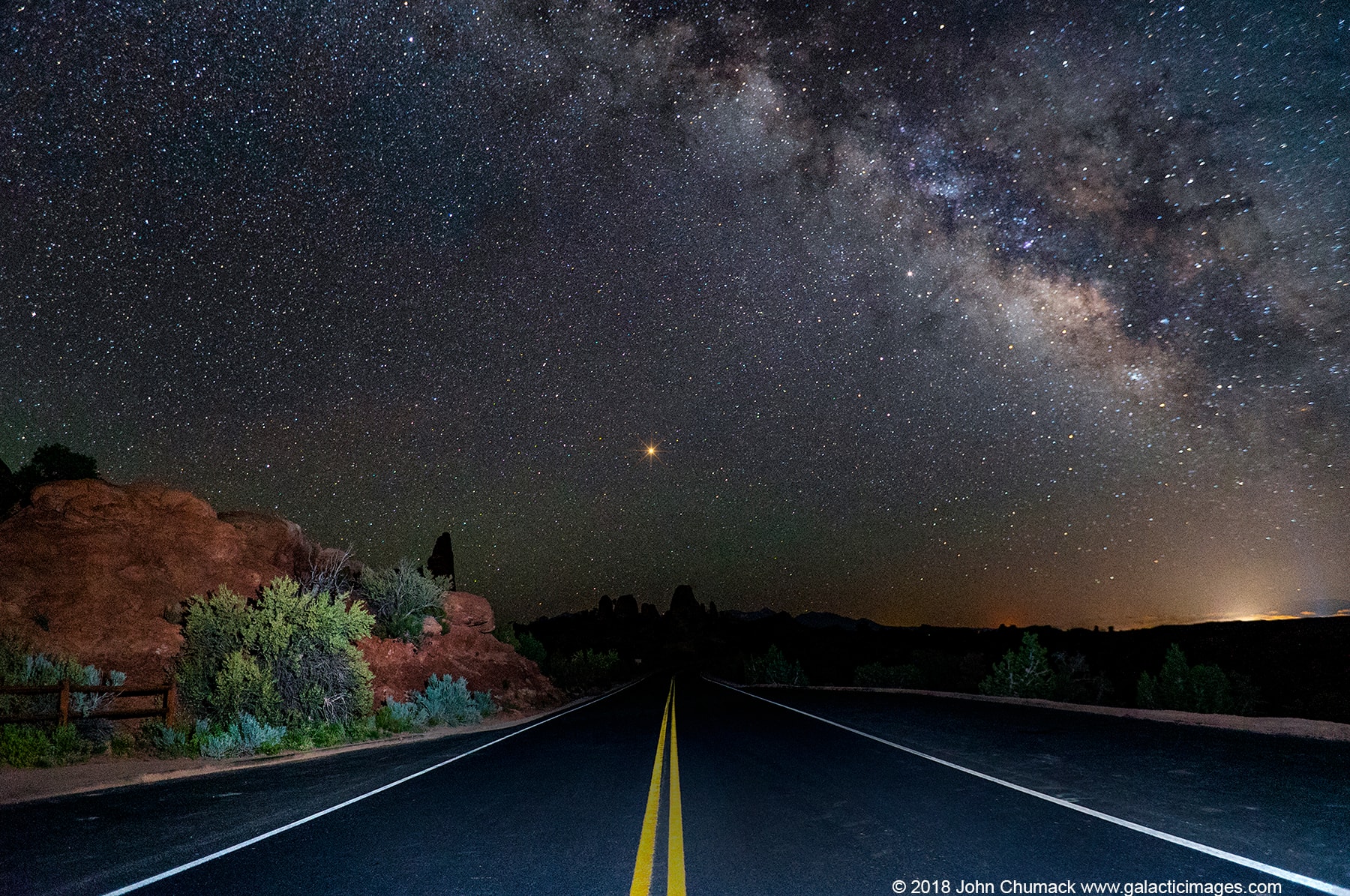 What's that light at the end of the road? Mars. This is a good month to point out Mars to your friends and family because our neighboring planet will not only be its brightest in 15 years, it will be visible for much of night. During this month, Mars will be about 180 degrees around from the Sun, and near the closest it ever gets to planet Earth.  In terms of orbits, Mars is also nearing the closest point to the Sun in its elliptical orbit, just as Earth moves nearly between it and the Sun -- an alignment known as perihelic opposition. In terms of viewing, orange Mars will rise in the east just as the Sun sets in the west, on the opposite side of the sky. Mars will climb in the sky during the night, reach its highest near midnight, and then set in the west just as the Sun begins to rise in the east.  The red planet was captured setting beyond a stretch of road in Arches National Park in mid-May near Moab, Utah, USA.