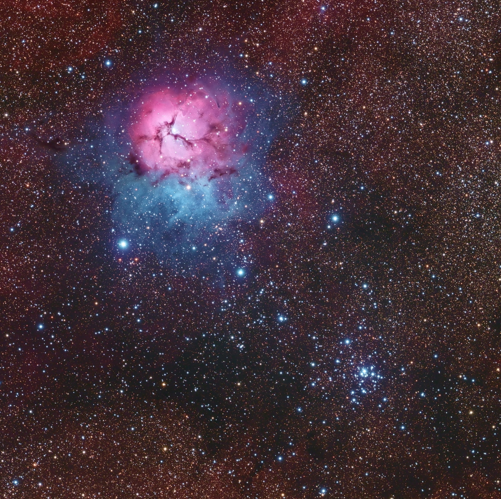 The beautiful Trifid Nebula, also known as Messier 20, is easy to find with a small telescope in the nebula rich constellation Sagittarius. About 5,000 light-years away, the colorful study in cosmic contrasts shares this well-composed, nearly 1 degree wide field with open star cluster Messier 21 (bottom right). Trisected by dust lanes the Trifid itself is about 40 light-years across and a mere 300,000 years old. That makes it one of the youngest star forming regions in our sky, with newborn and embryonic stars embedded in its natal dust and gas clouds. Estimates of the distance to open star cluster M21 are similar to M20's, but though they share this gorgeous telescopic skyscape there is no apparent connection between the two. In fact, M21's stars are much older, about 8 million years old.